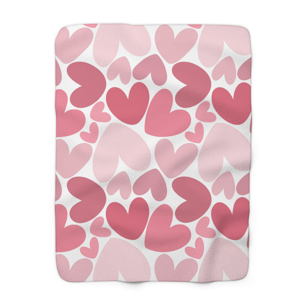 Fleece blanket with pink heart pattern on a white background
