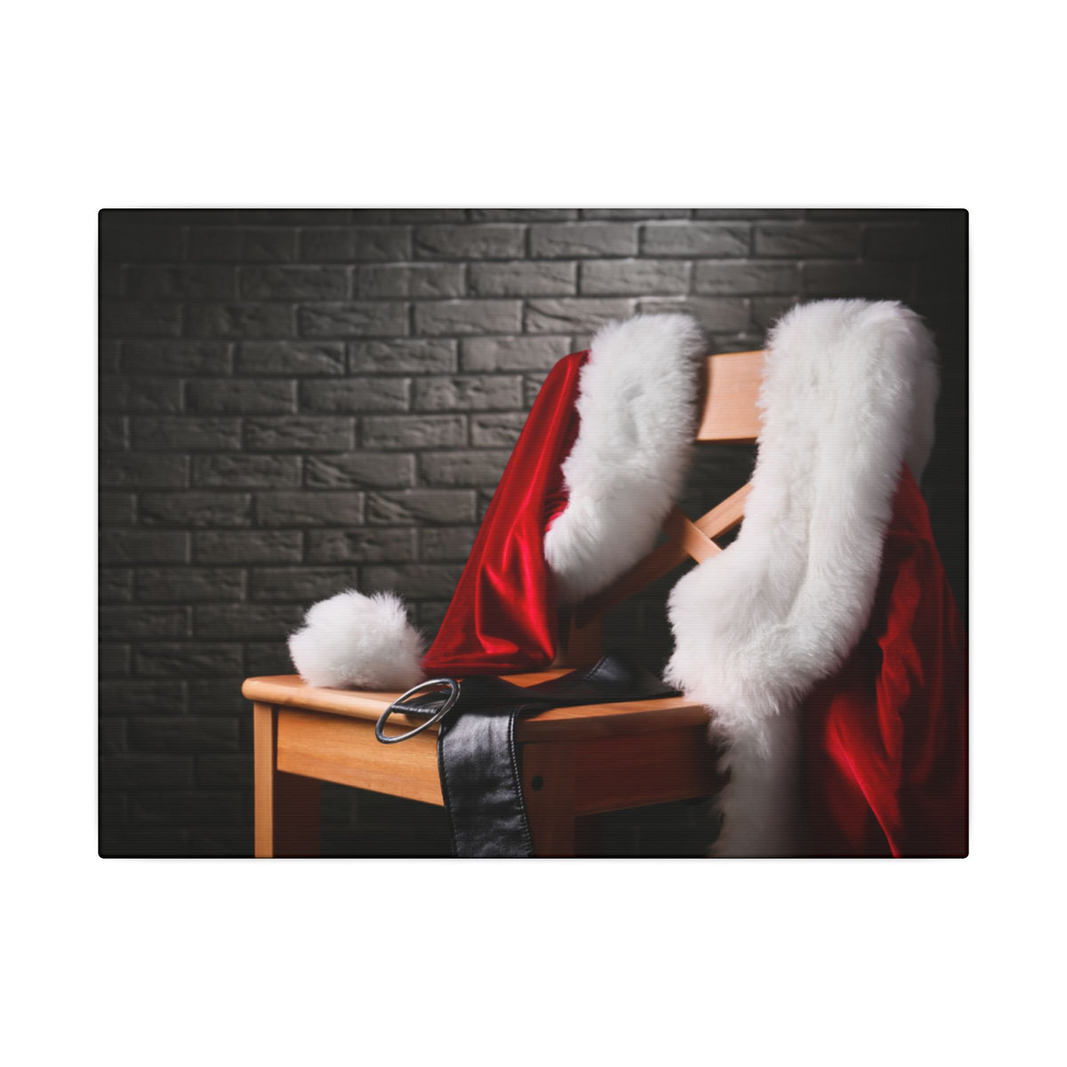 Santa Claus costume with red jacket, white fur trim, and black boots on a wooden chair against a brick wall.