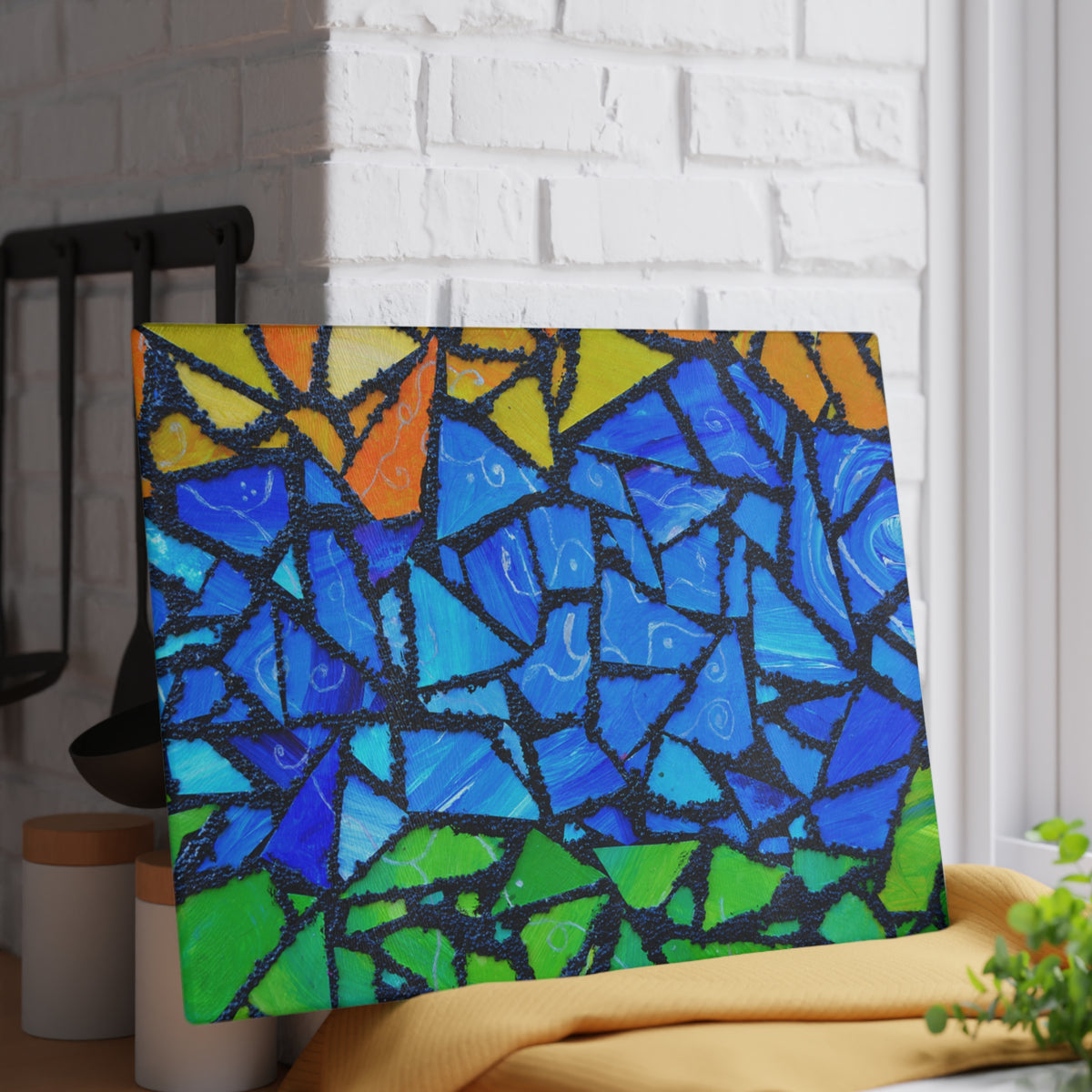 Colorful abstract mosaic art piece on a white brick wall.