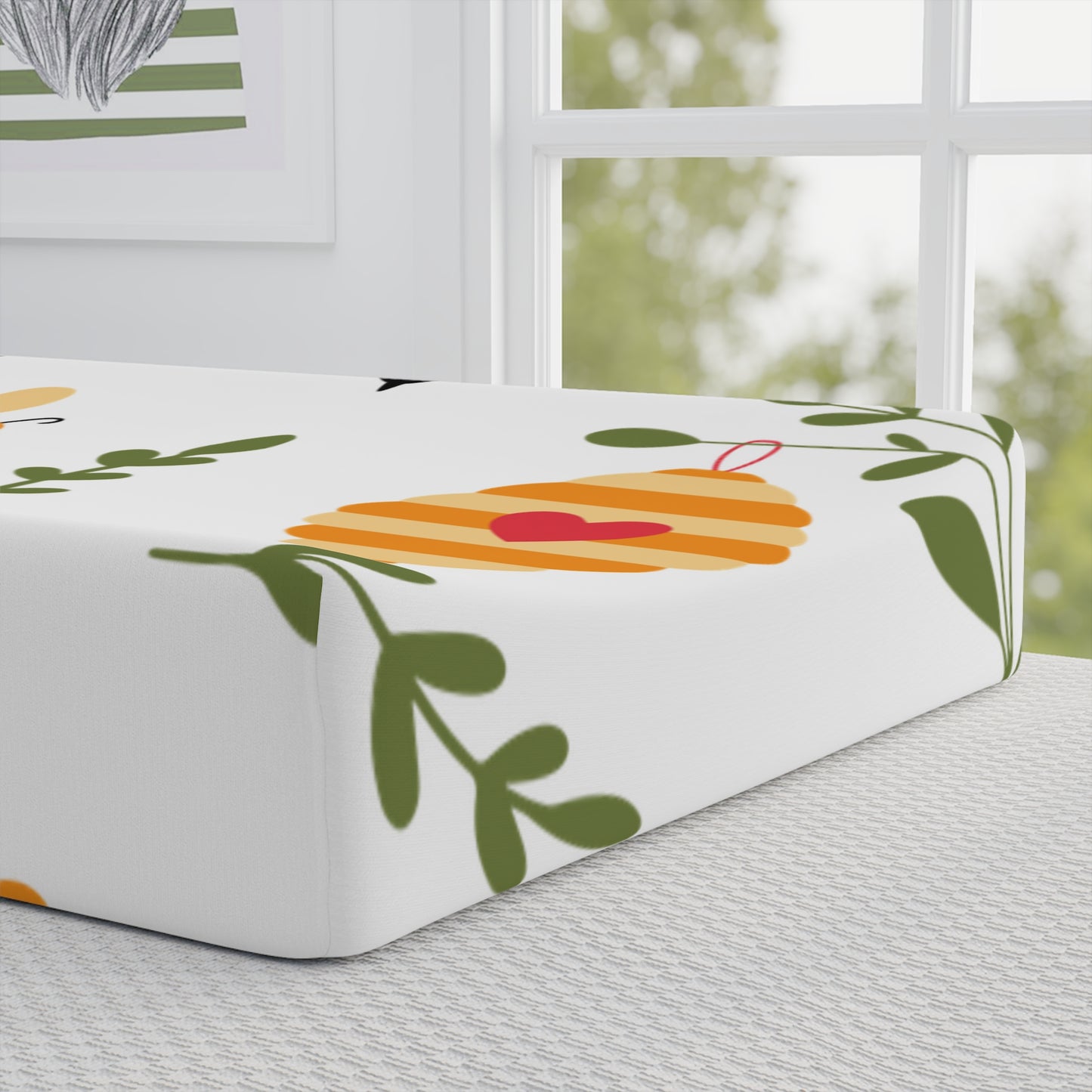 Fitted sheet with colorful designs on a bed in a room with a window.