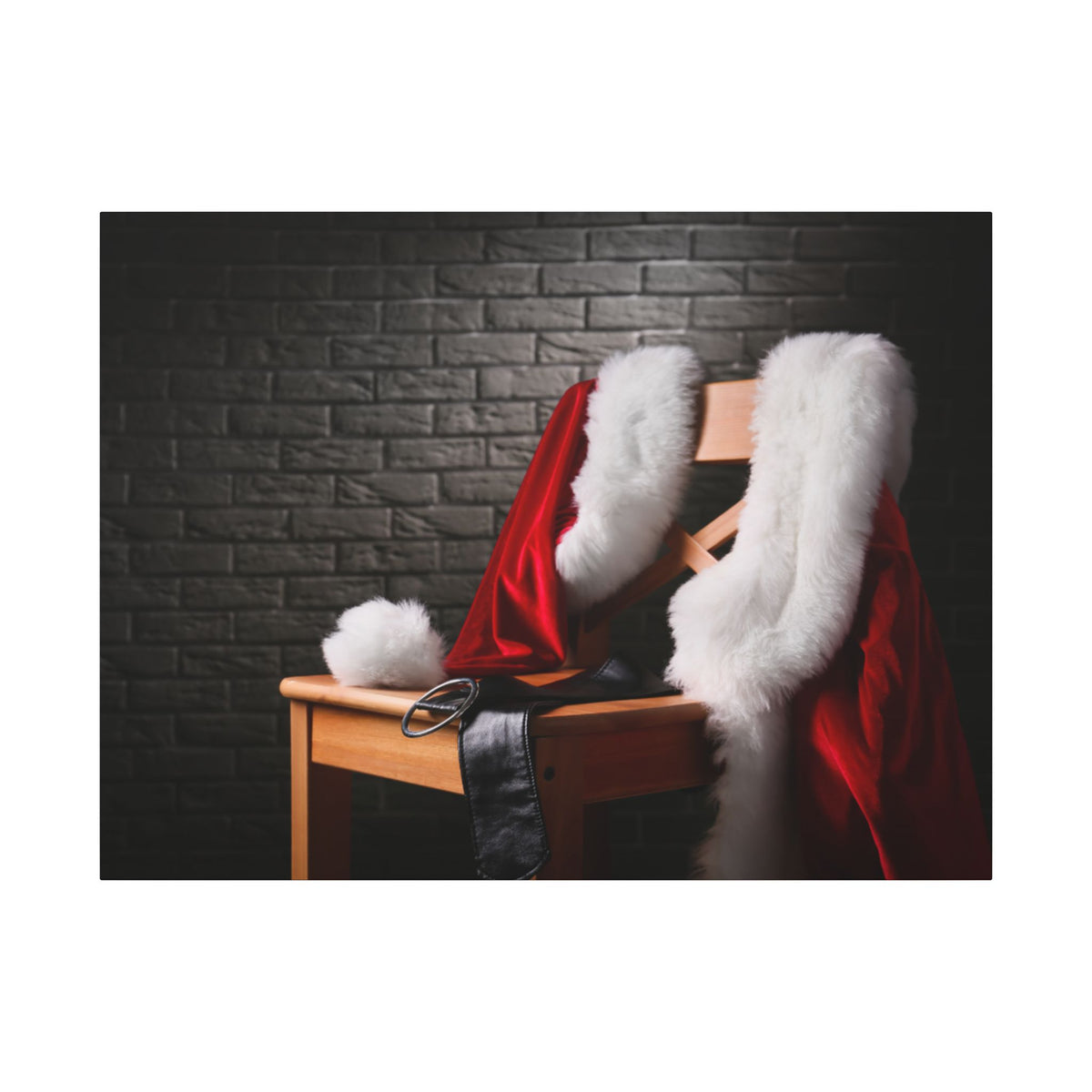 Santa Claus costume with red robe and white fur on a wooden chair against a dark brick wall.