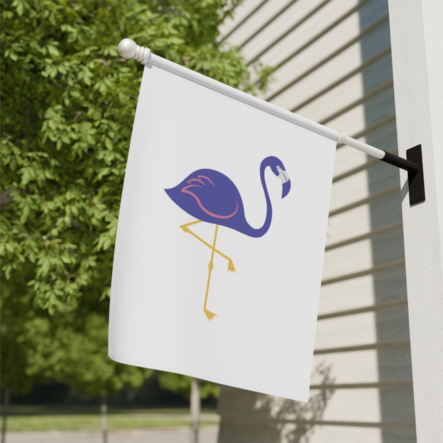 White flag with a purple flamingo design attached to a building exterior.