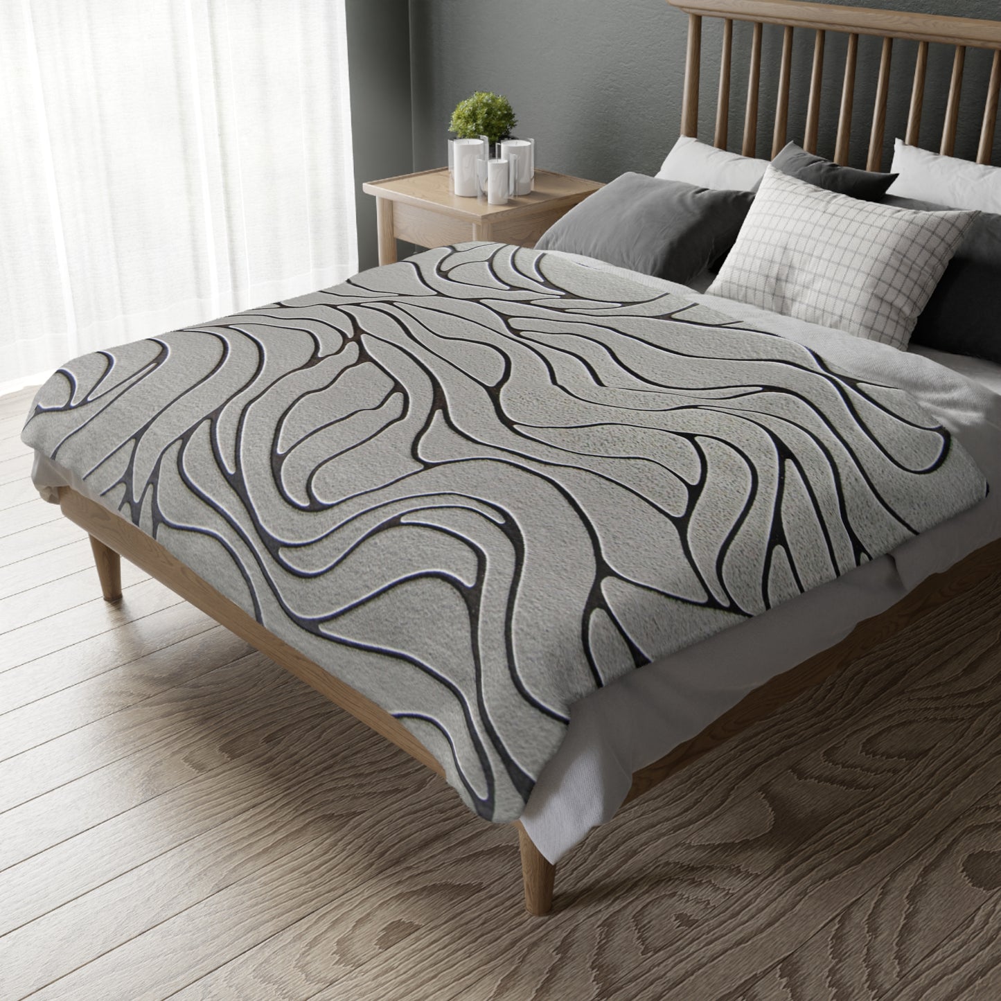 Bed with a patterned duvet cover in a bedroom setting