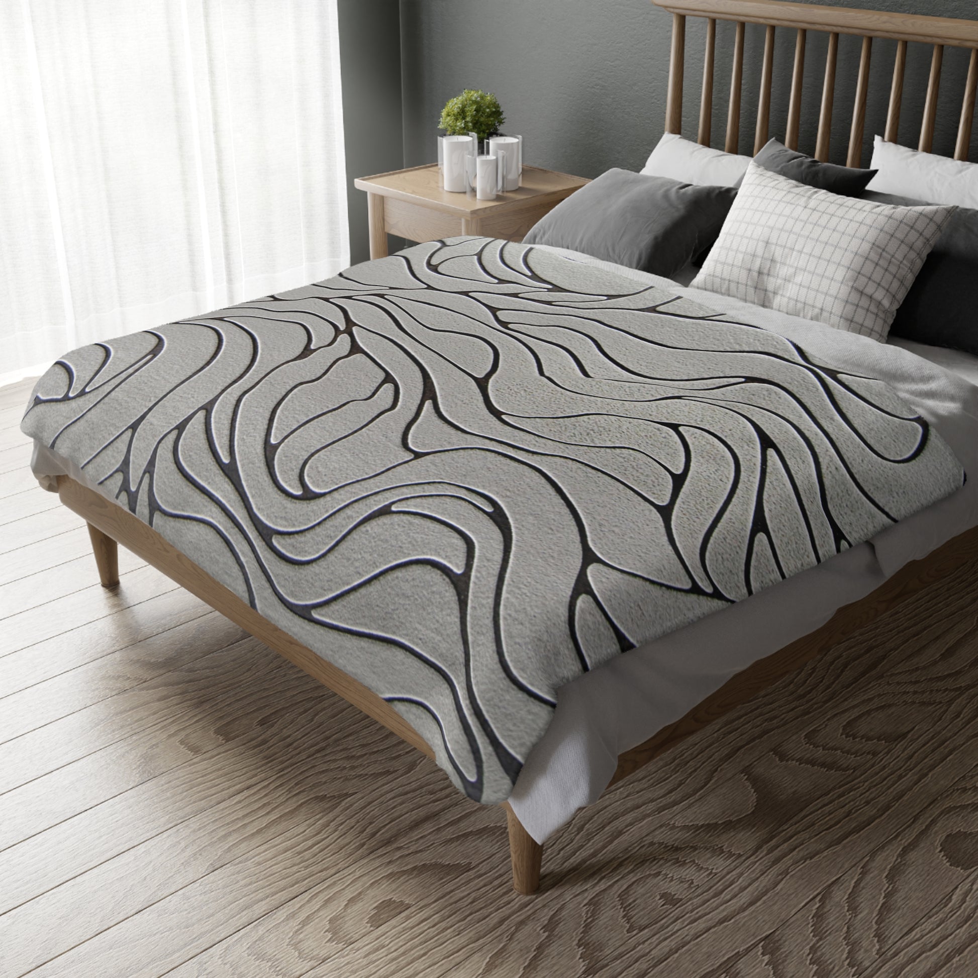 Bed with a patterned duvet cover in a bedroom setting
