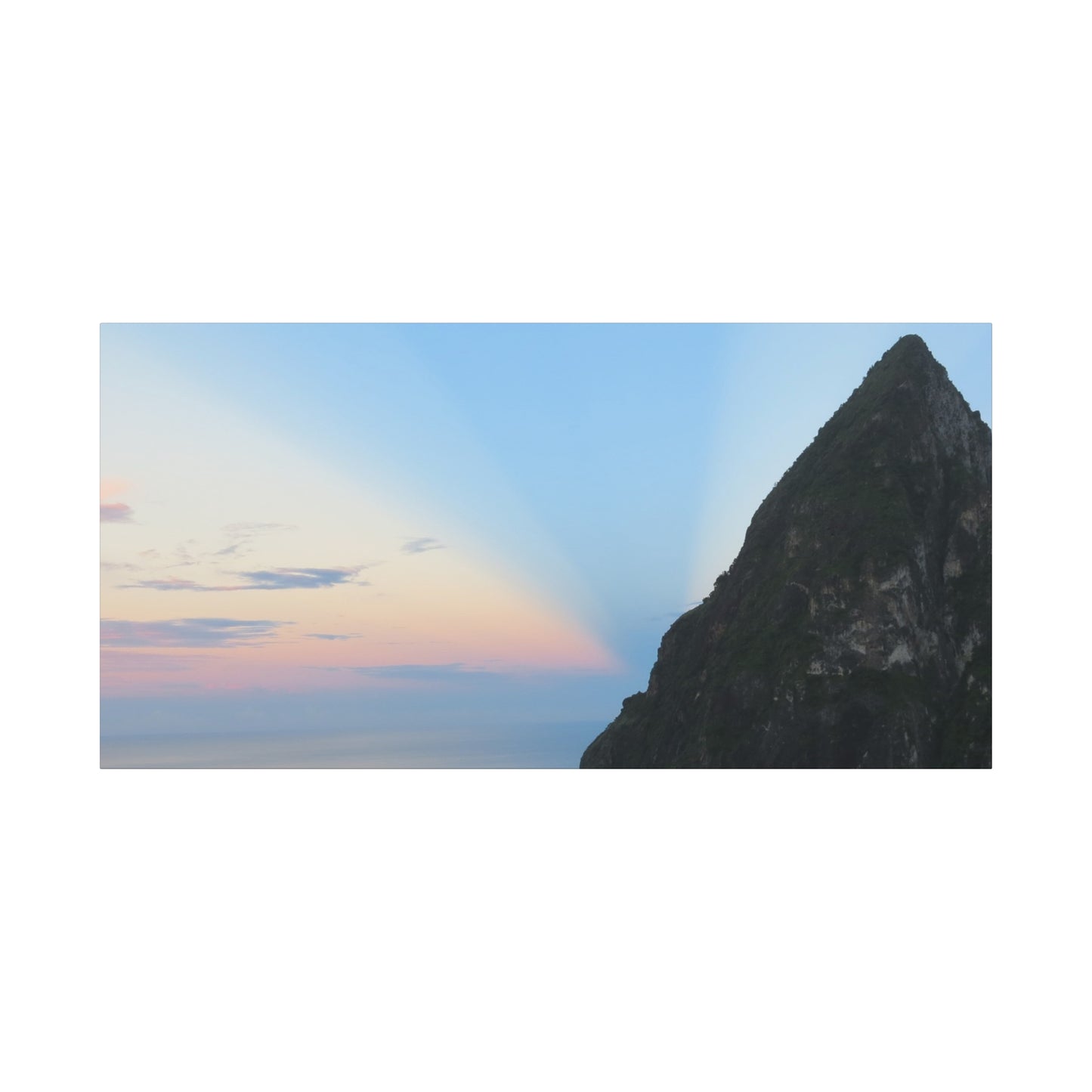 Mountain peak with a rainbow in the sky