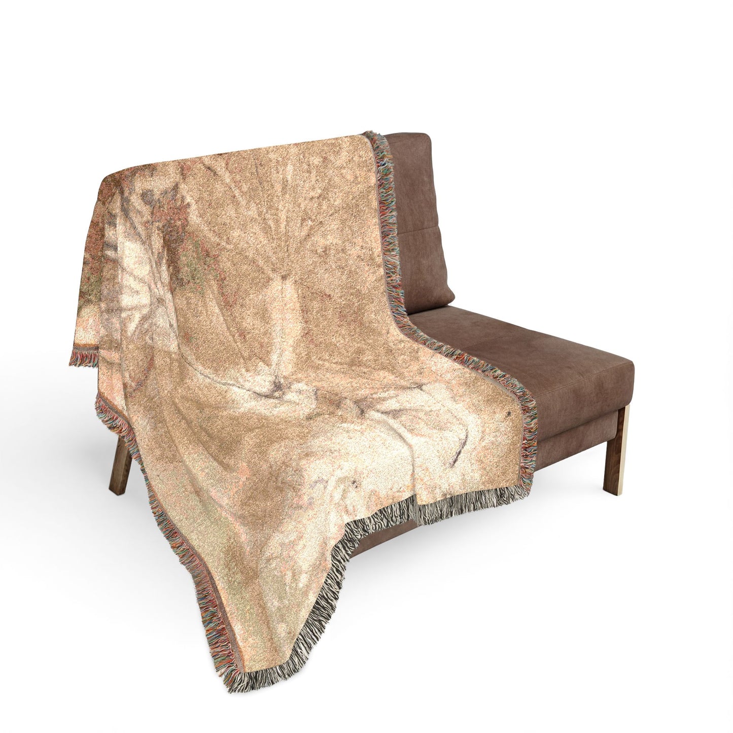 Beige patterned throw blanket draped over a brown chair on a white background