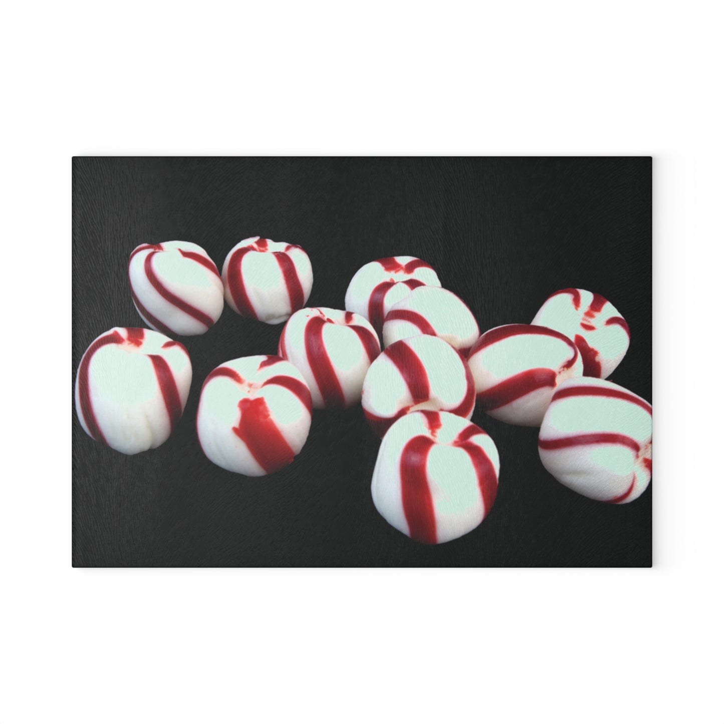 Red and white striped candies on a black background