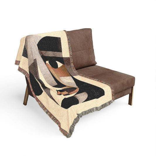 Brown chair with a decorative blanket featuring abstract patterns on a white background
