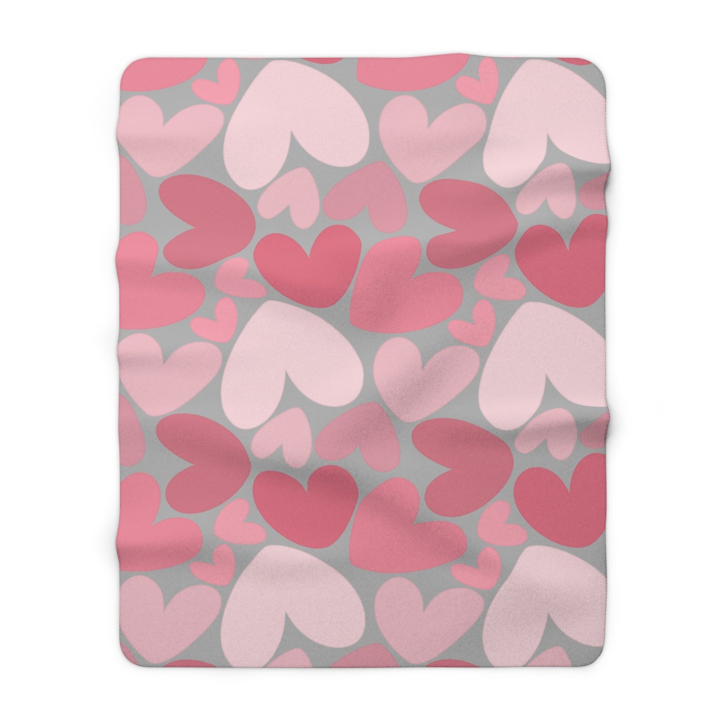 Fleece blanket with pink and red heart pattern on gray background