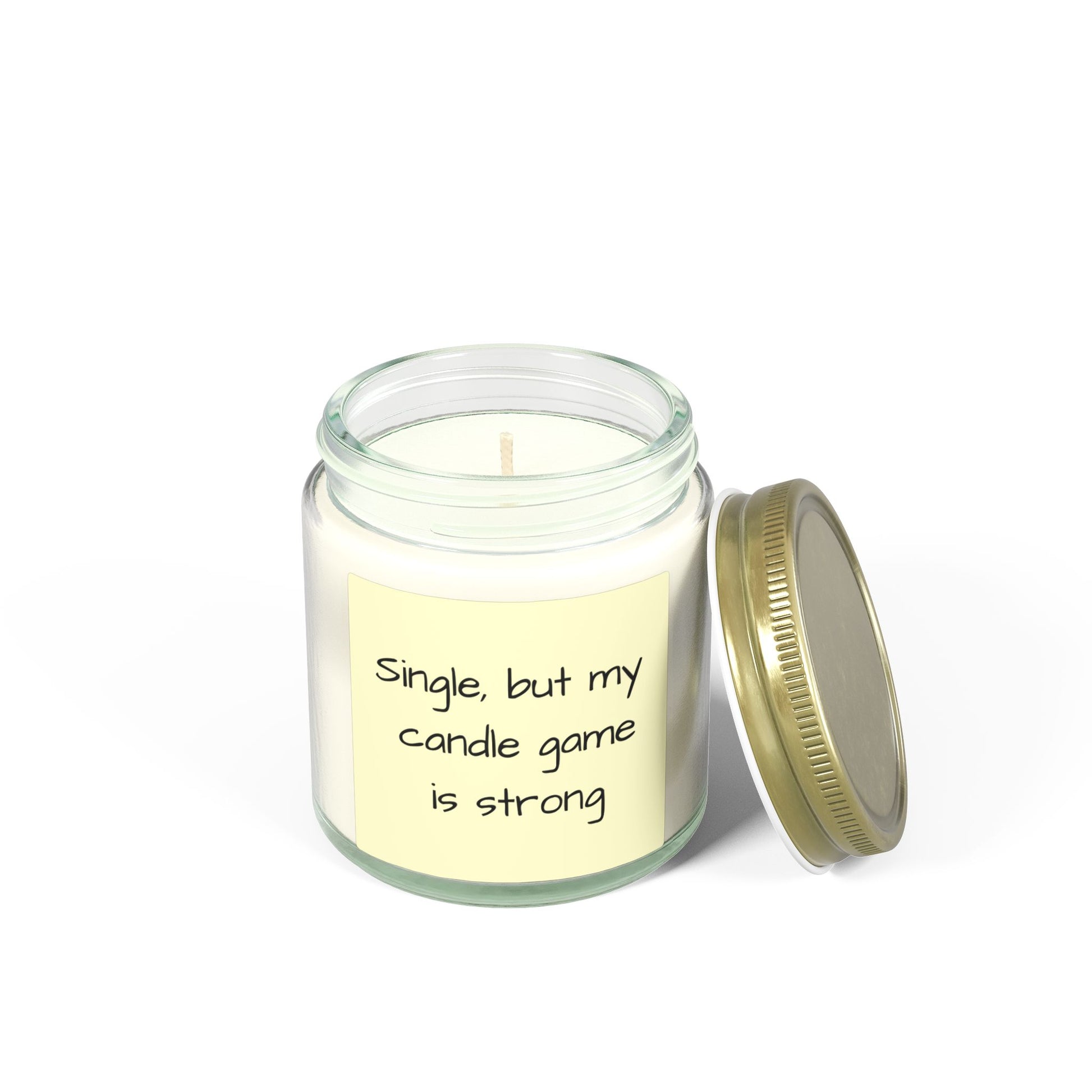 Candle in a glass jar with a gold lid and a humorous label on a white background