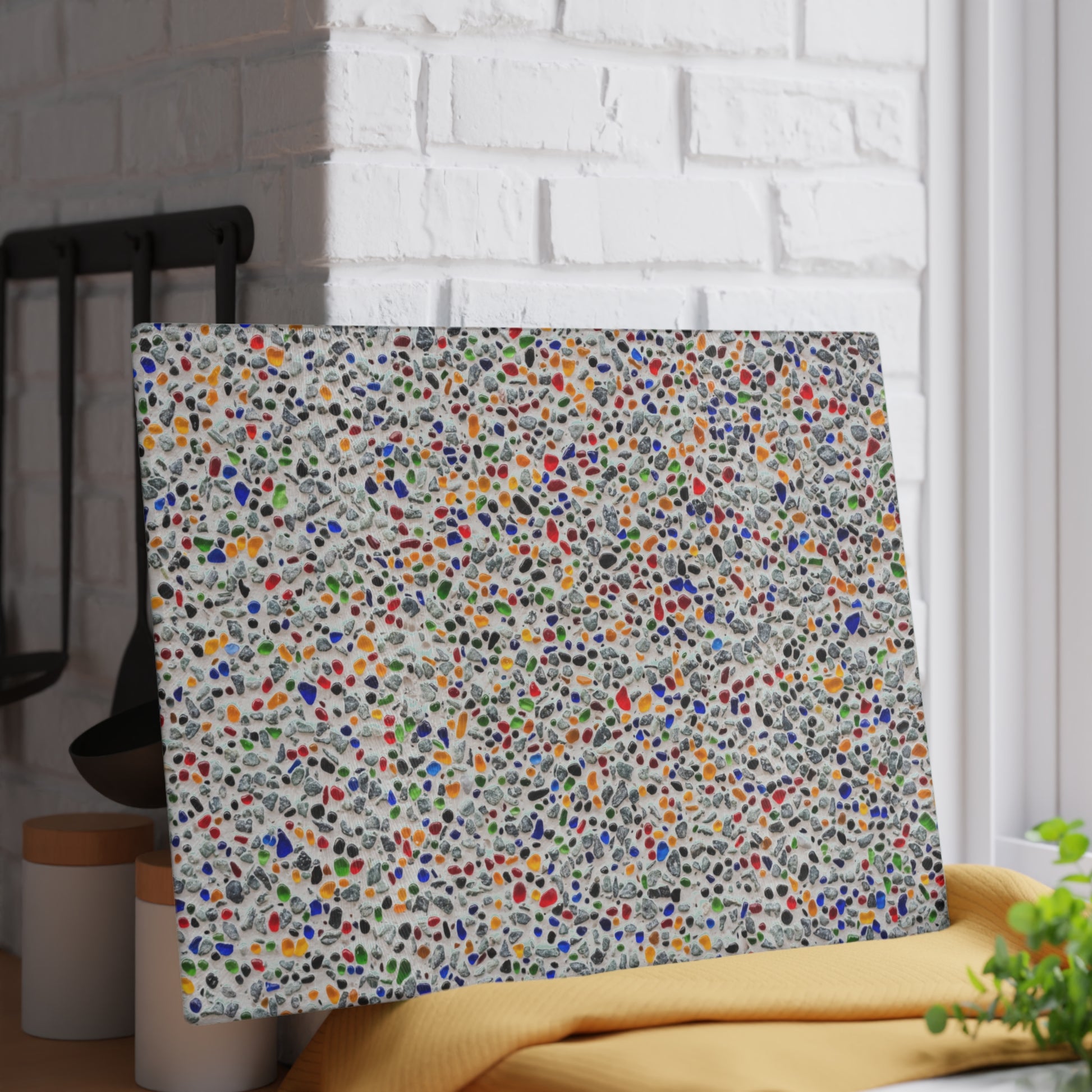Multicolored polka dot headboard against a white brick wall.