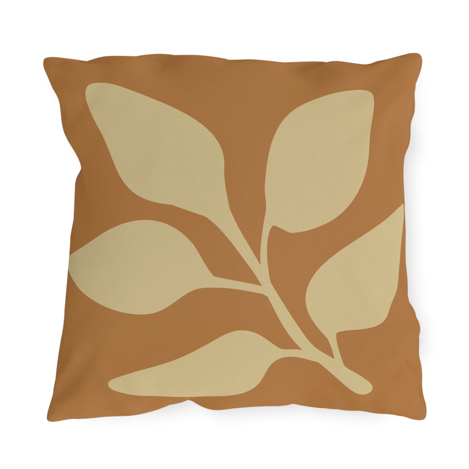 Decorative pillow with leaf pattern on a brown background