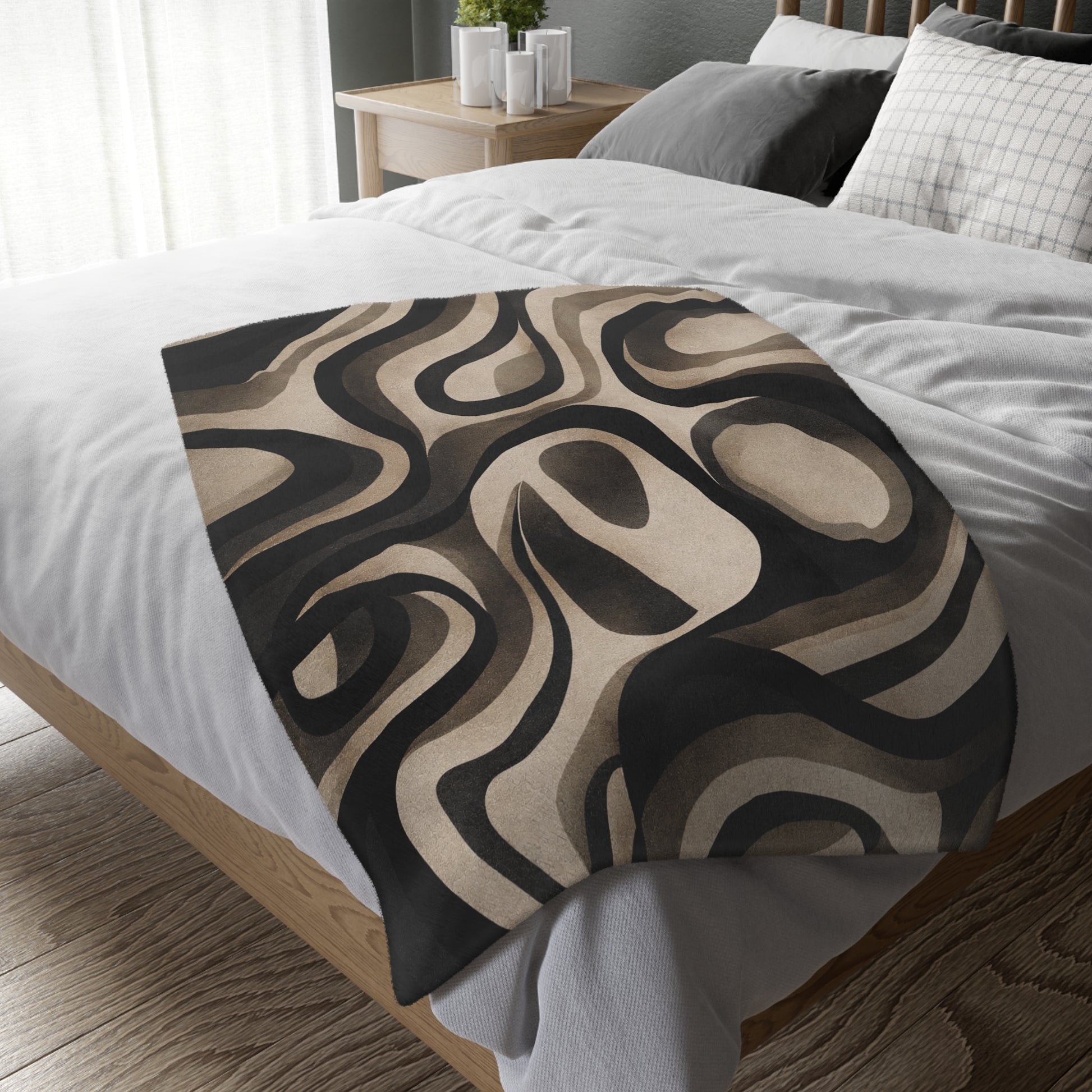 Patterned throw blanket on a bed in a bedroom setting