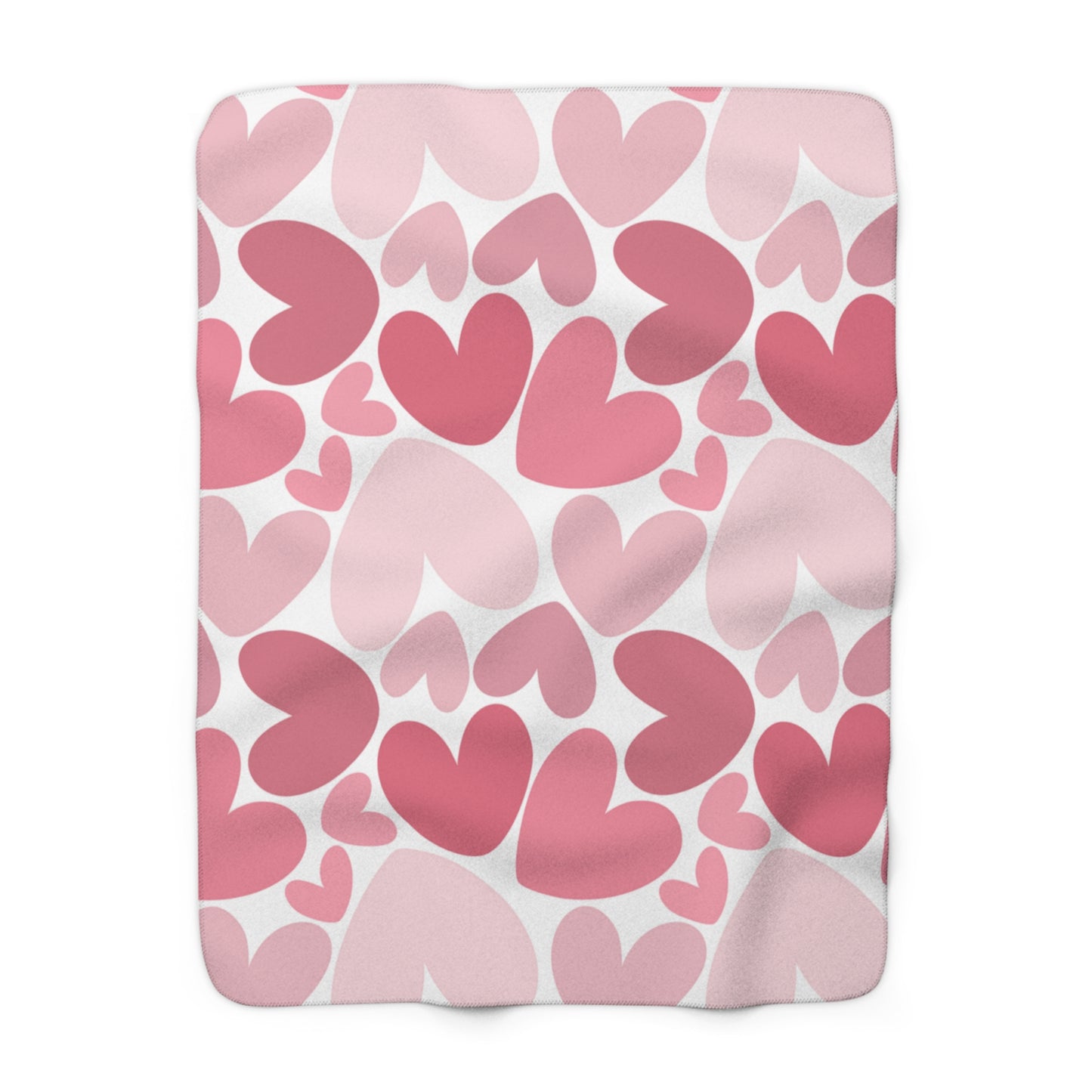 Fleece blanket with pink heart pattern on a white background