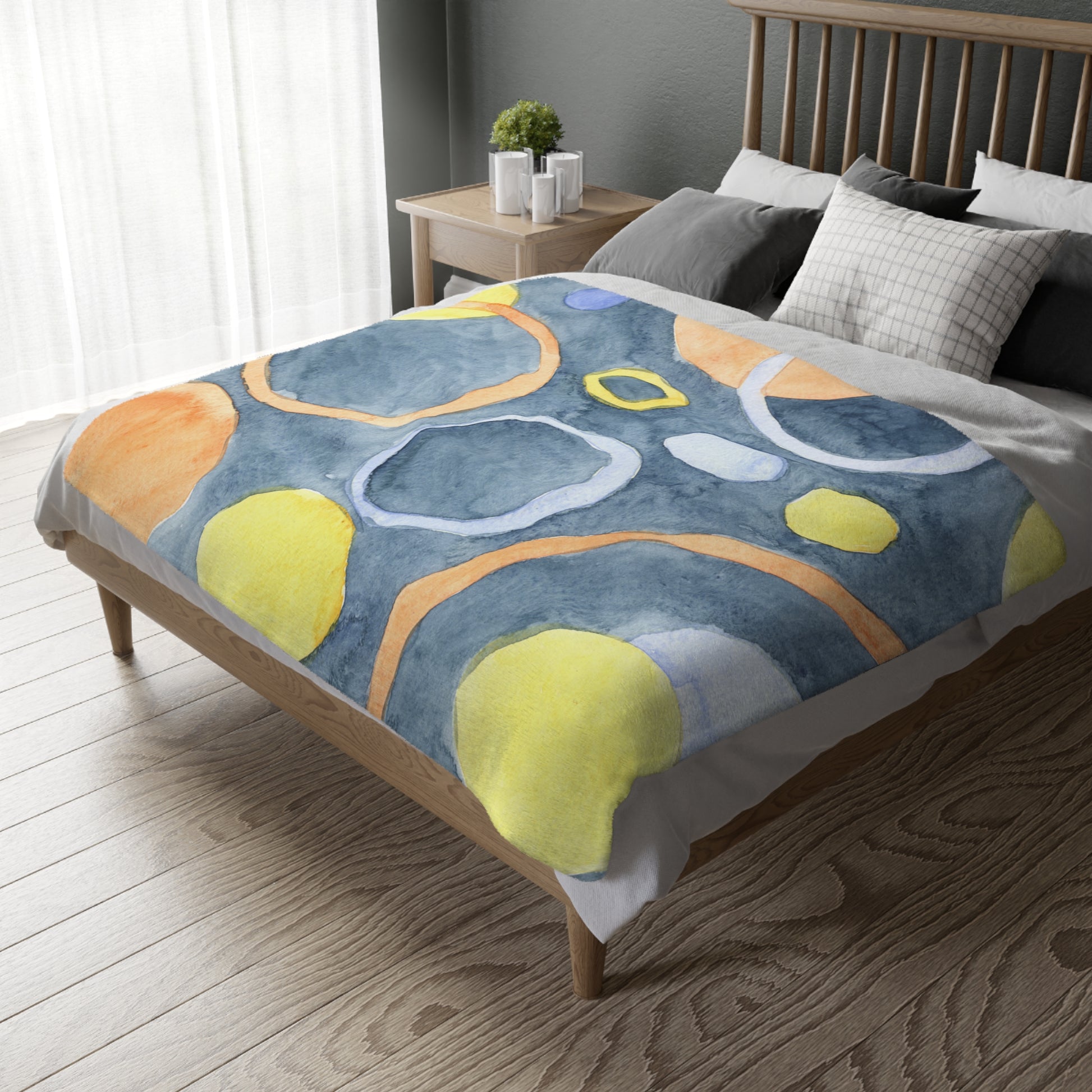 Bed with a colorful abstract patterned comforter in a bedroom setting.