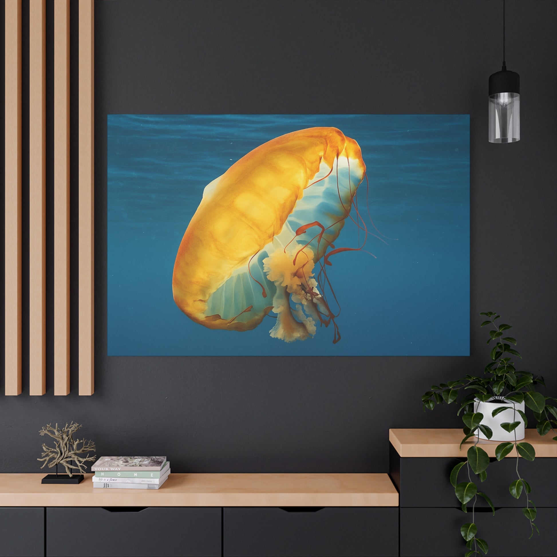 Framed artwork of a jellyfish on a dark wall with a wooden shelf below.