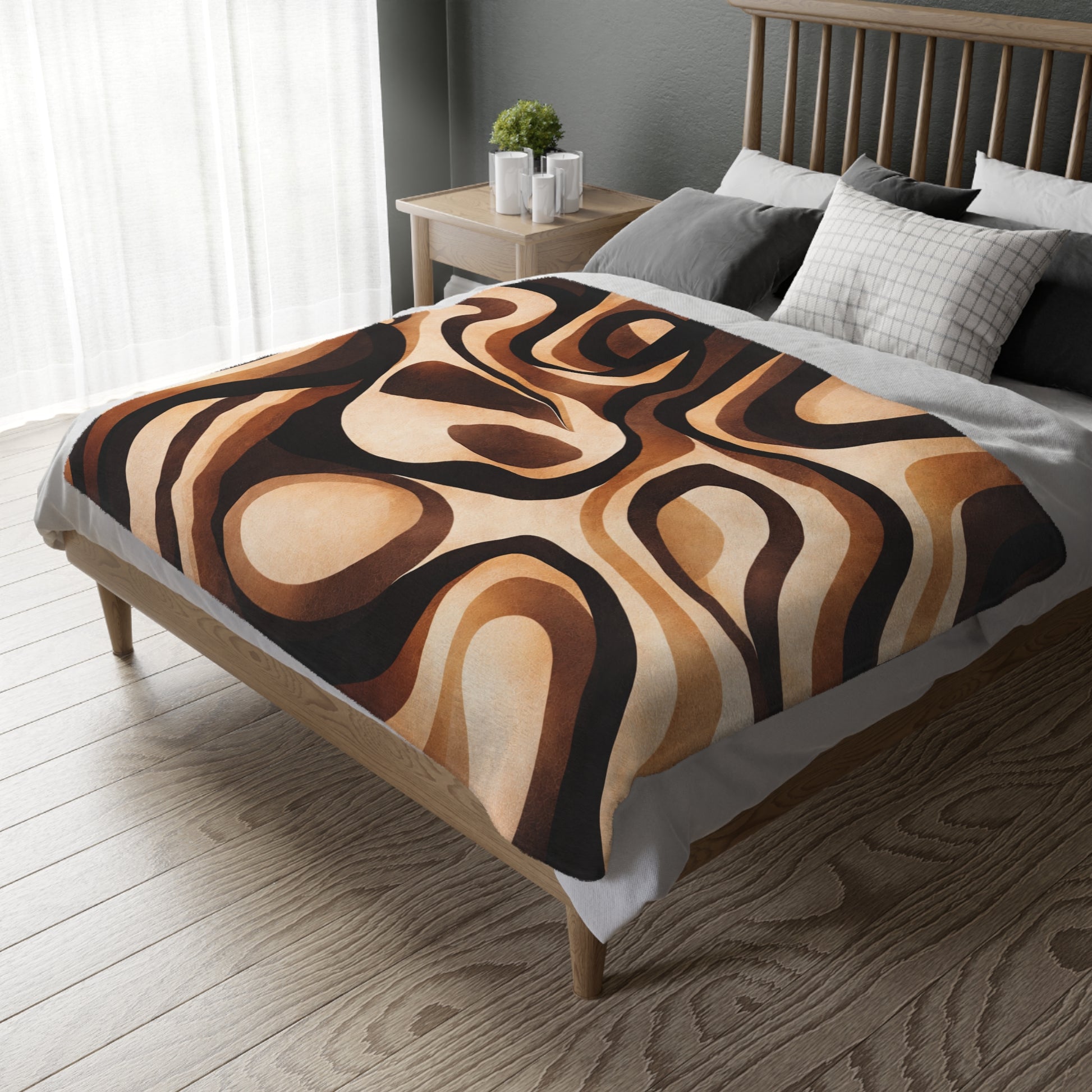 Bed with a patterned brown and beige blanket in a bedroom setting.