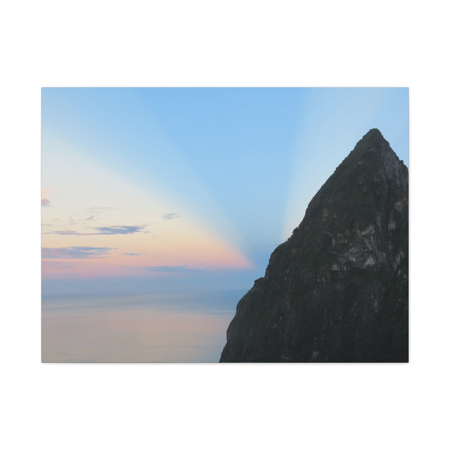 Mountain peak with a rainbow in the sky