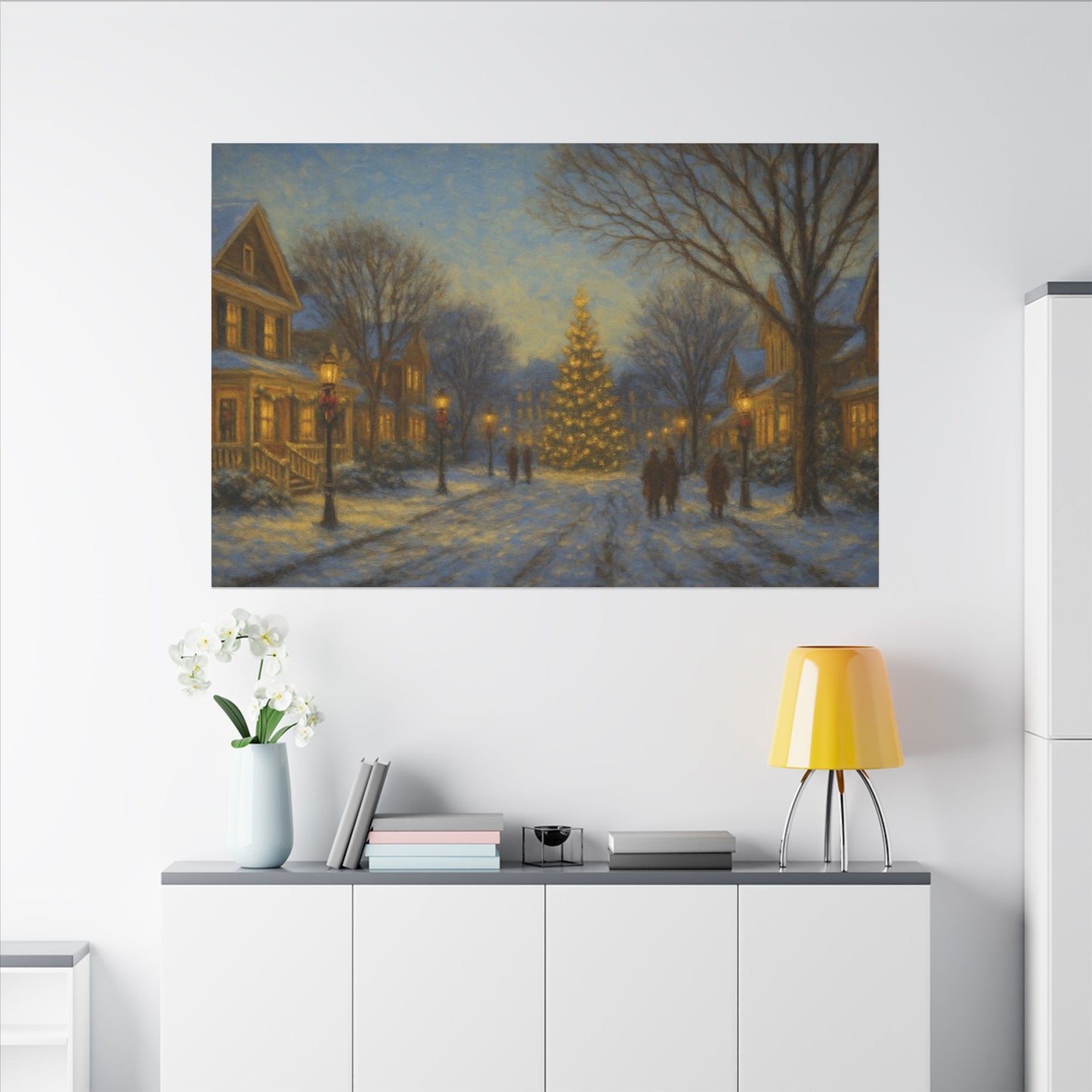 Framed winter scene painting on a wall above a white cabinet with decorative items.