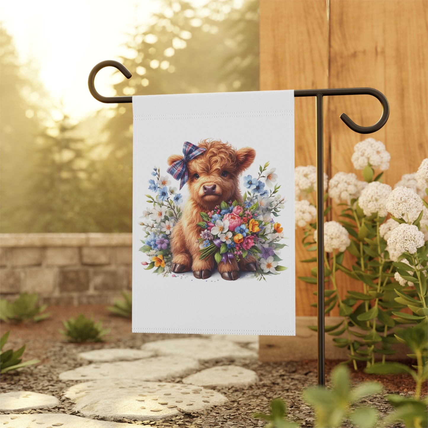 Garden flag with a dog holding flowers on a stand outdoors.