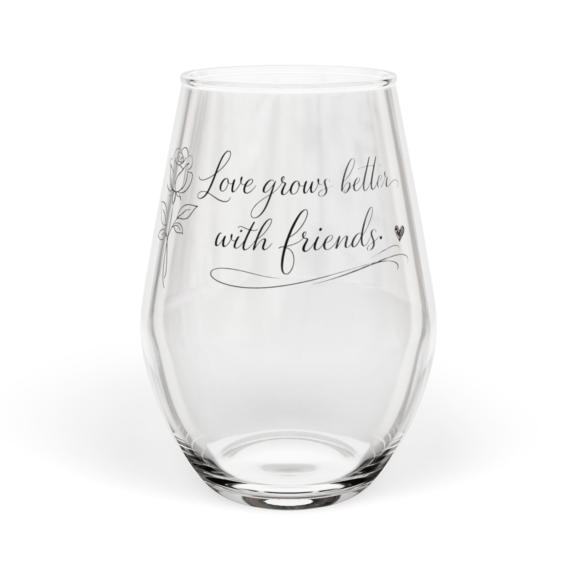 Clear glass wine glass with engraved text 'Love grows better with friends' on a white background