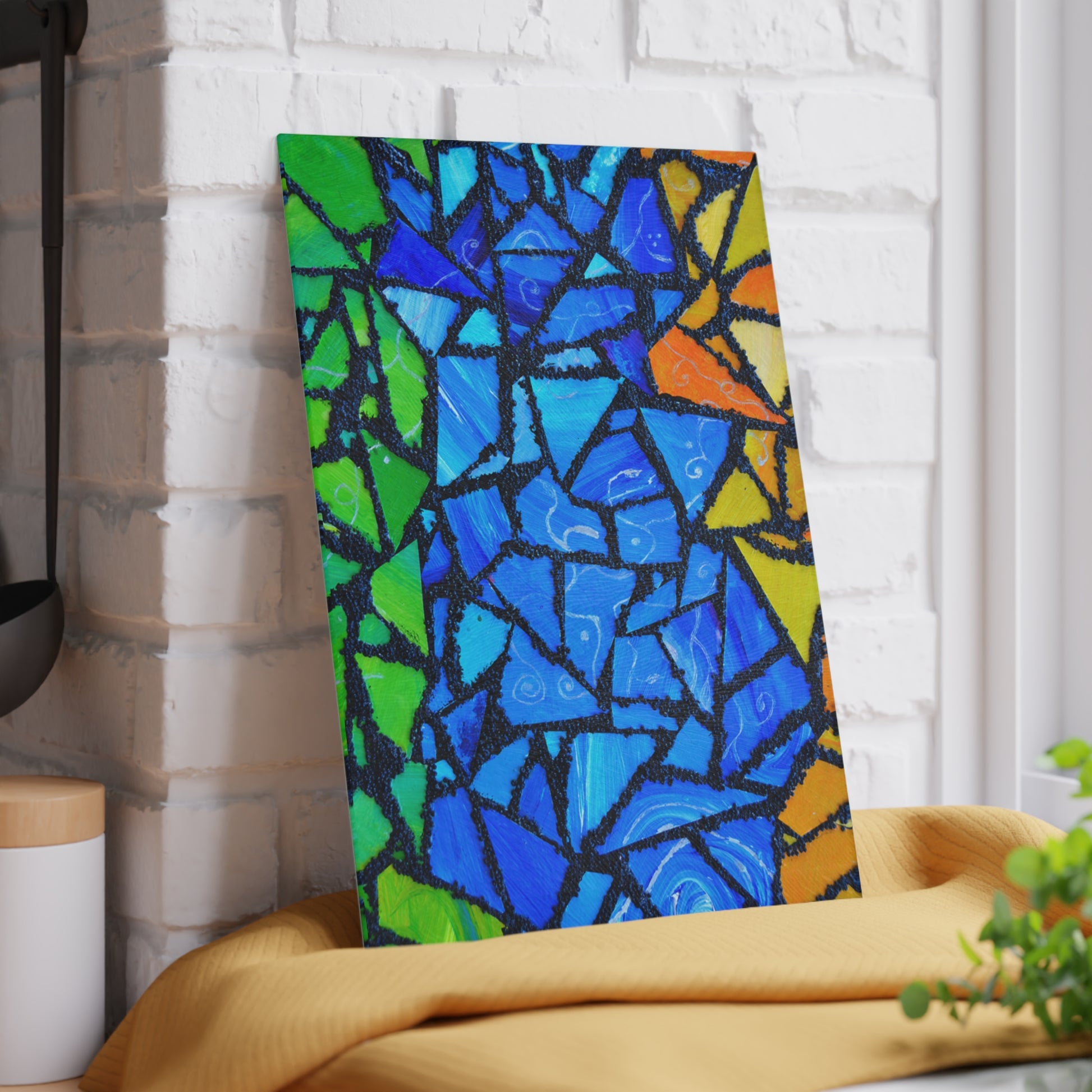 Colorful abstract mosaic art piece on a white brick wall.