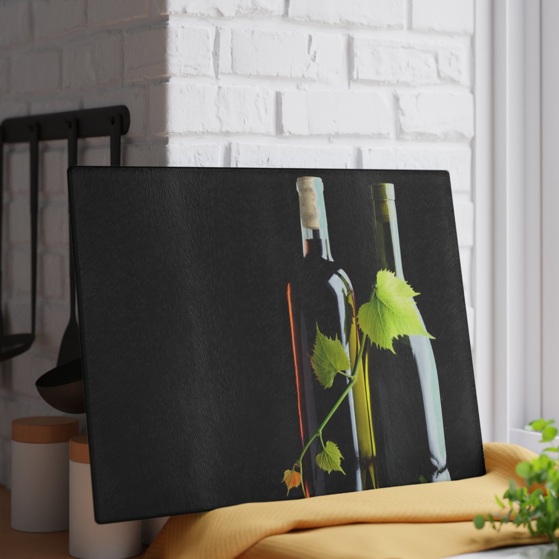 Black tablecloth with wine bottles and leaves on a white brick wall background