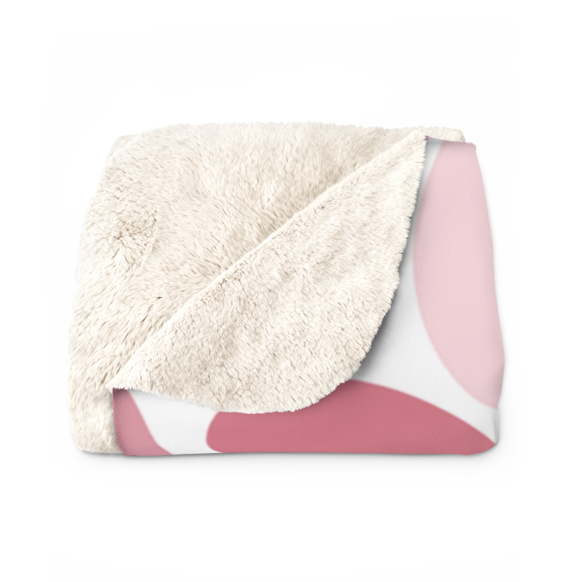 Folded blanket with white sherpa side and pink backside on a white background