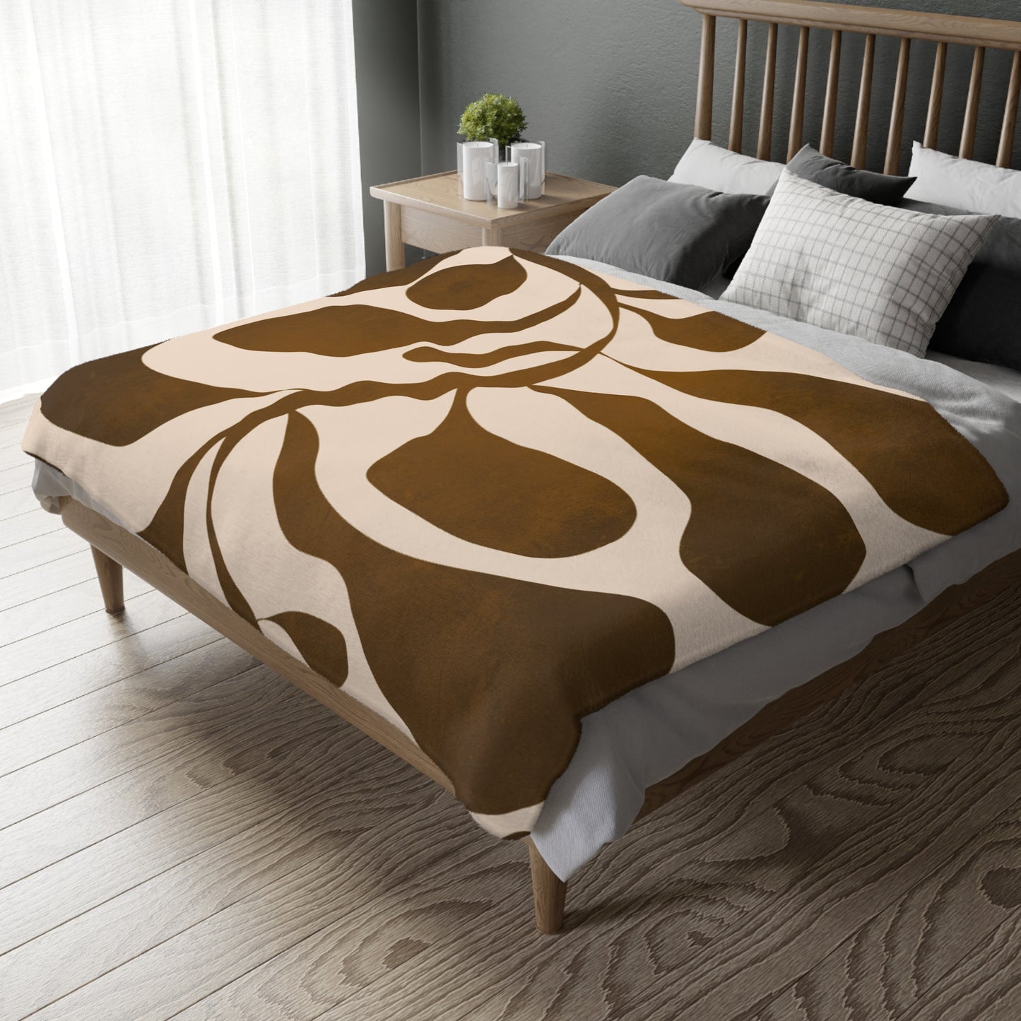 Bed with brown and beige patterned blanket in a bedroom setting