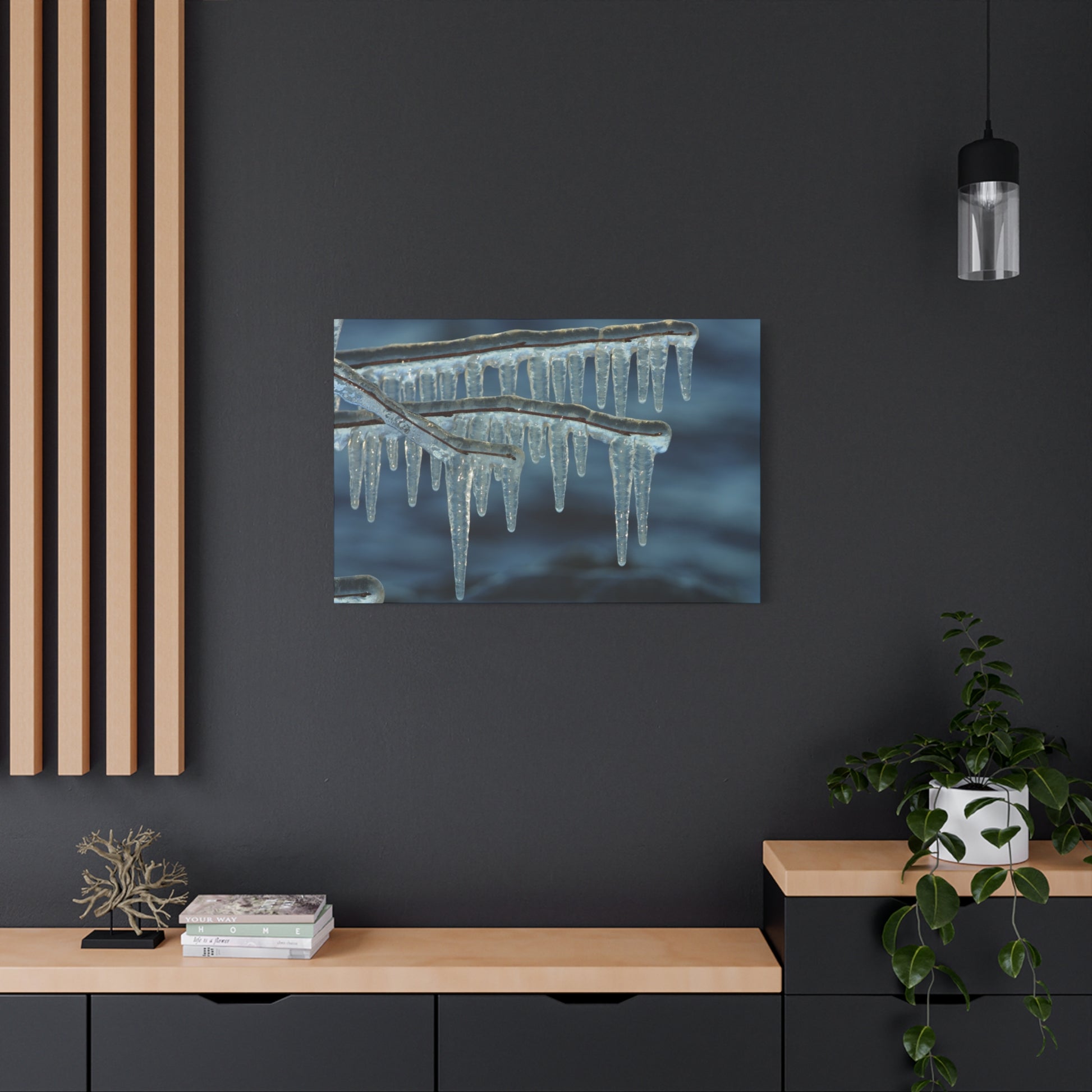 Framed photograph of icicles on a dark wall with wooden shelves and decor.