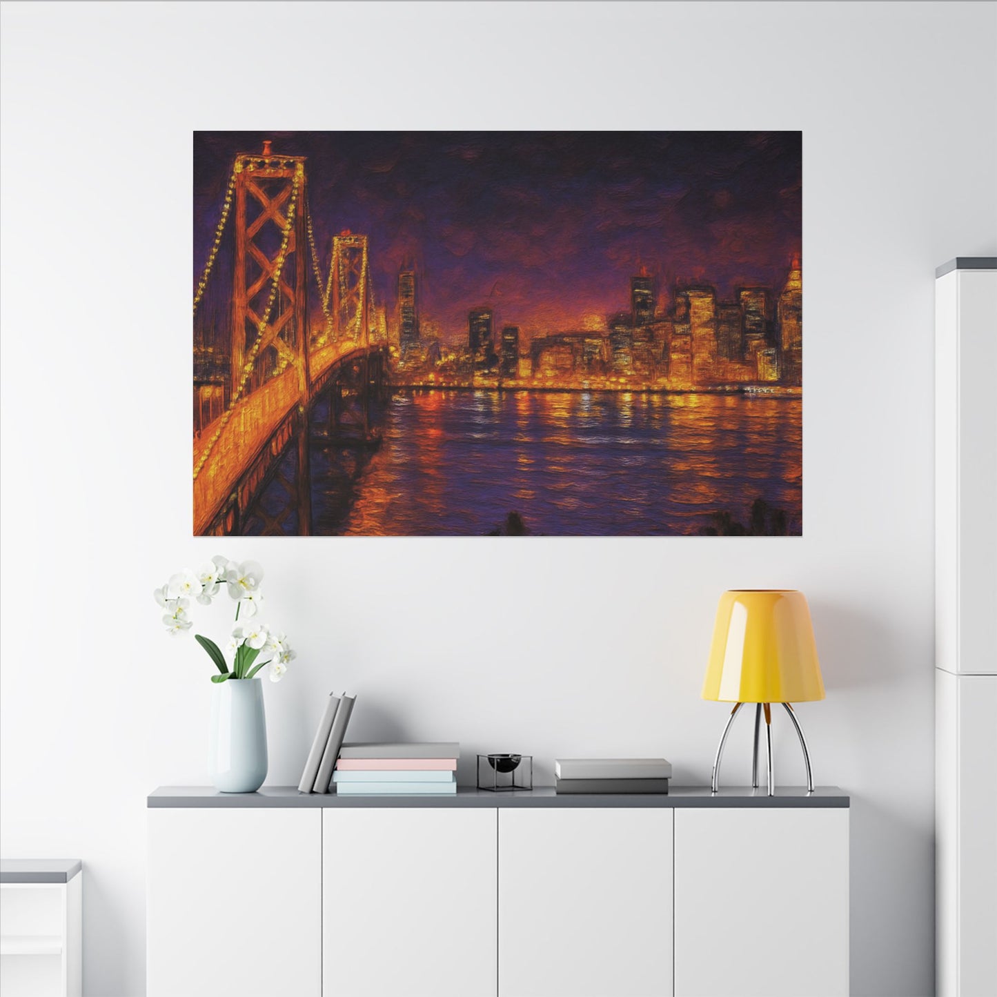 Cityscape painting on a wall above a white cabinet with a lamp and books.