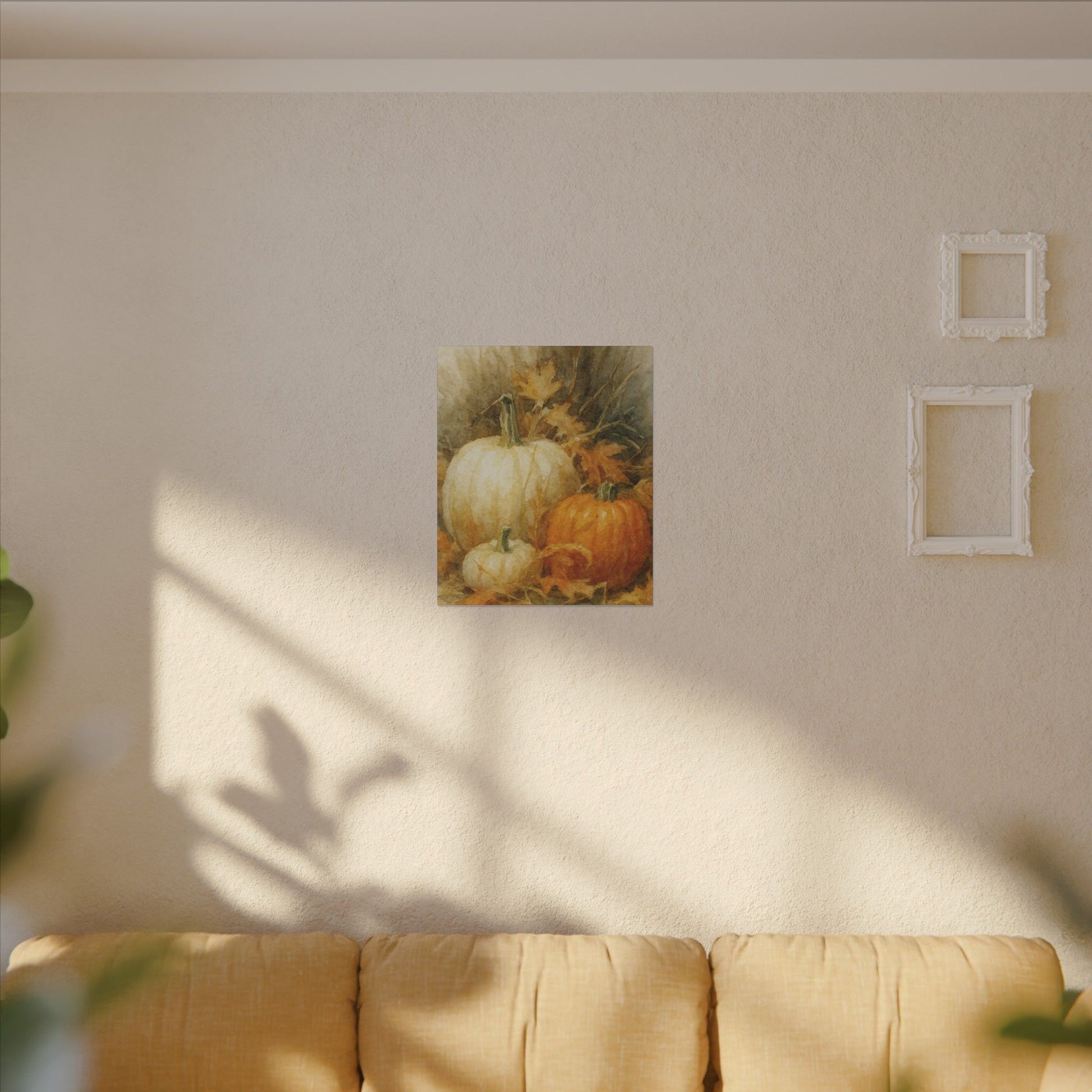 Framed artwork of pumpkins on a wall above a sofa