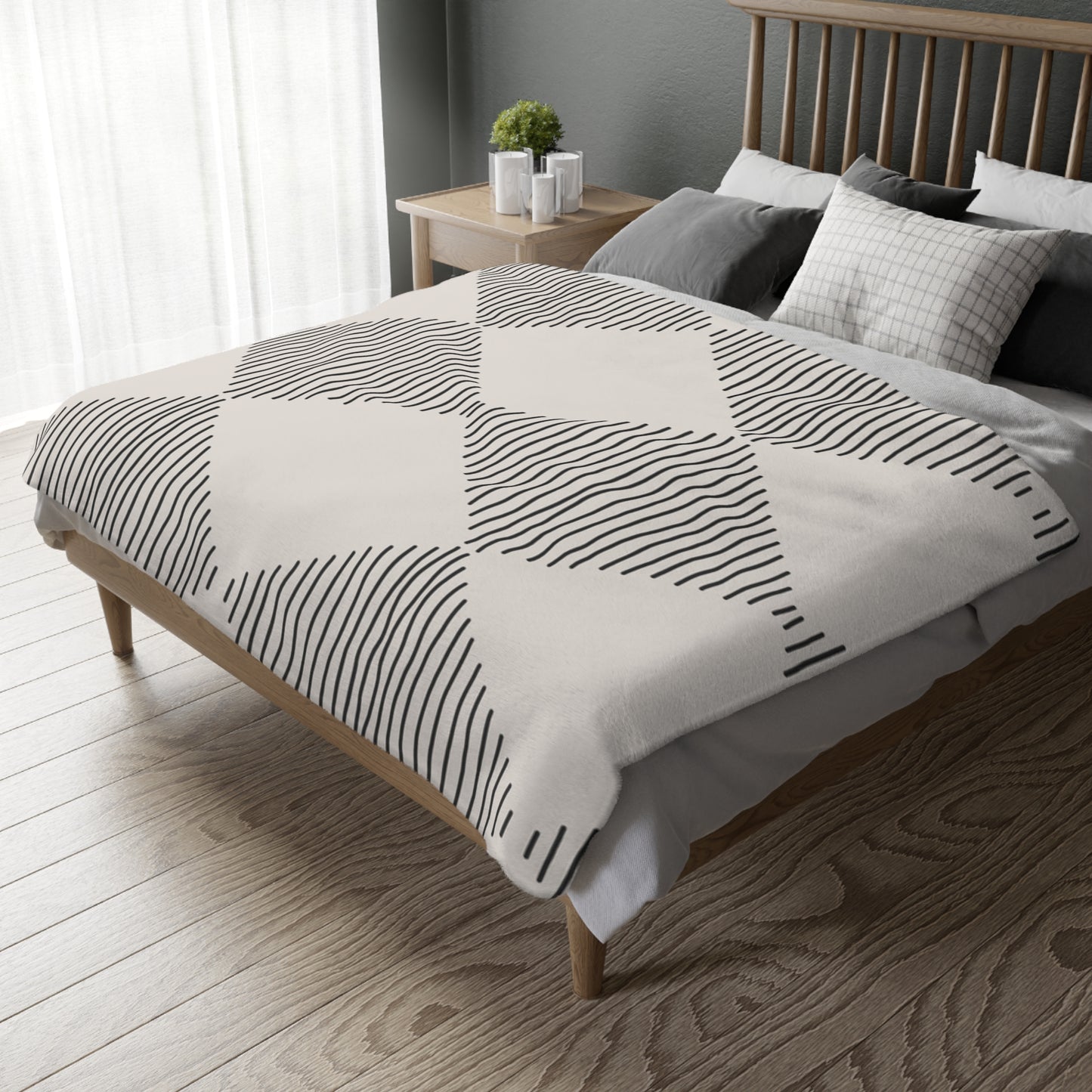 Bed with geometric-patterned comforter in a bedroom setting