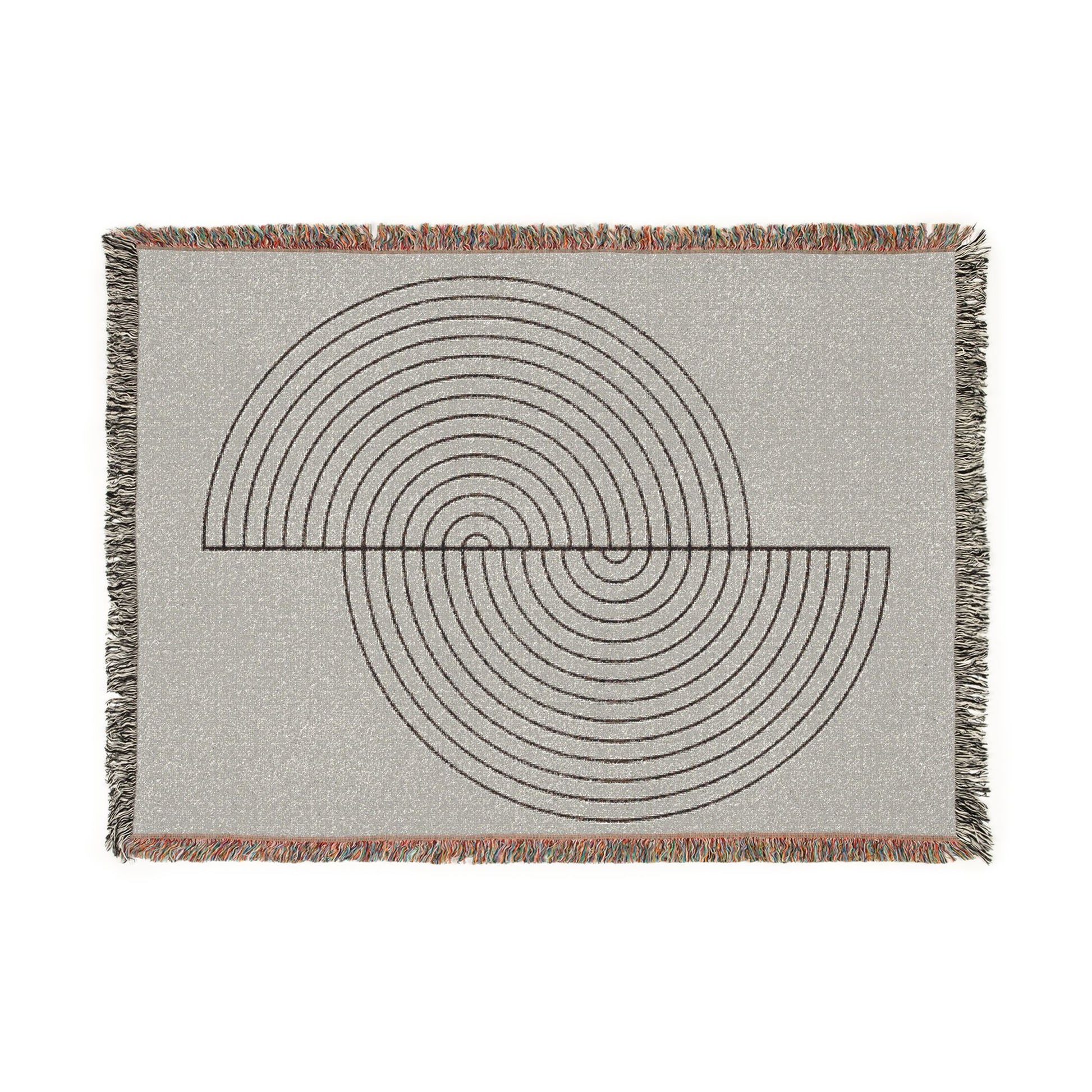 Woven blanket with geometric circular pattern on a plain background
