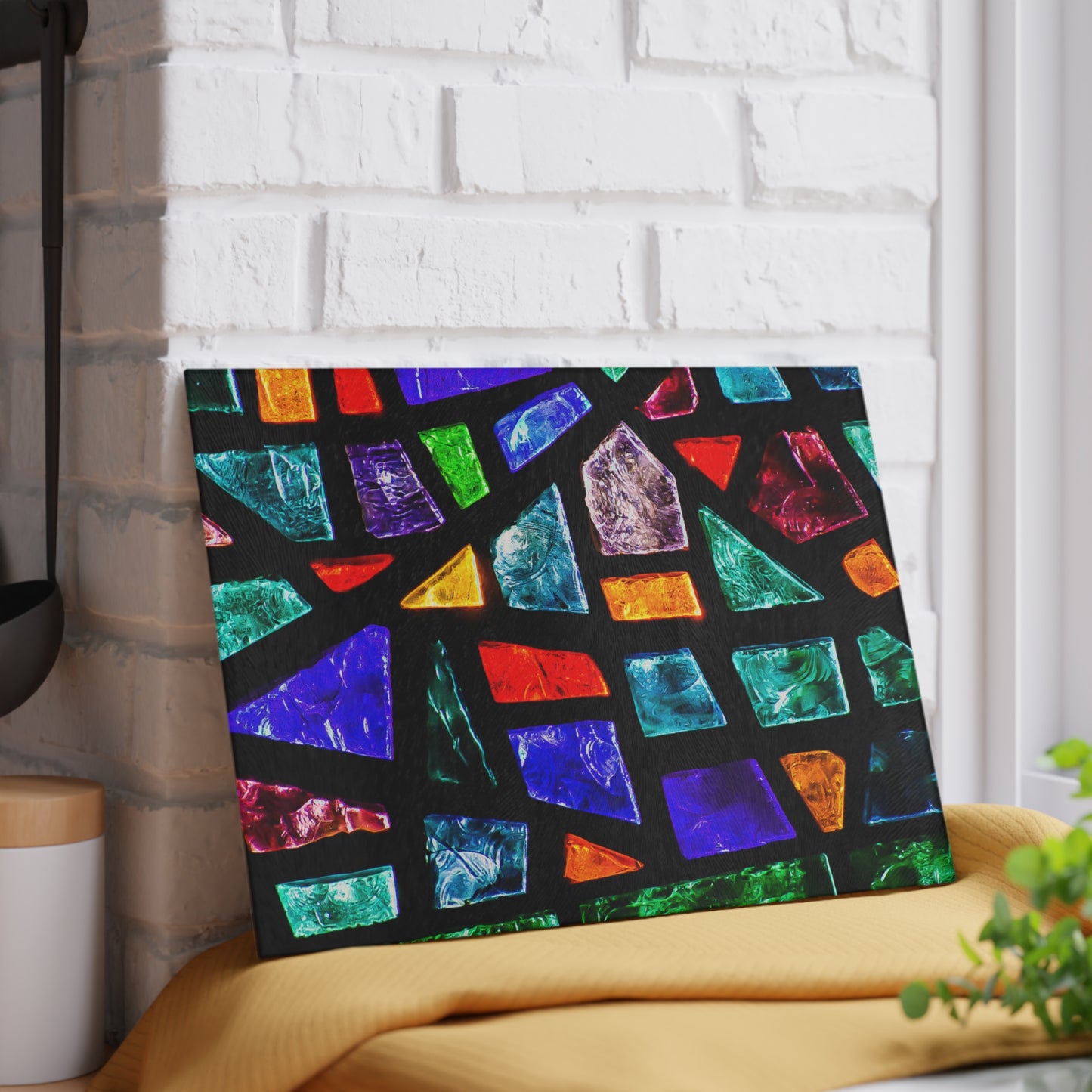 Colorful geometric patterned blanket on a chair against a white brick wall.