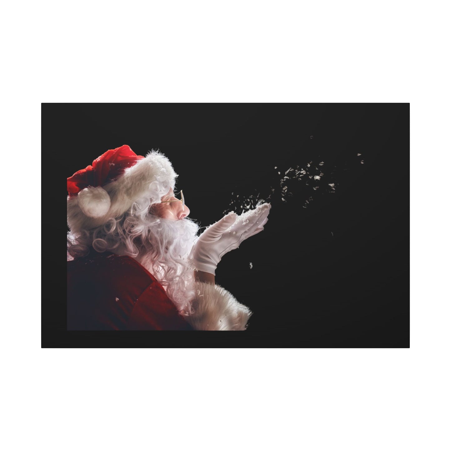 Santa Claus figure blowing snowflakes against a black background