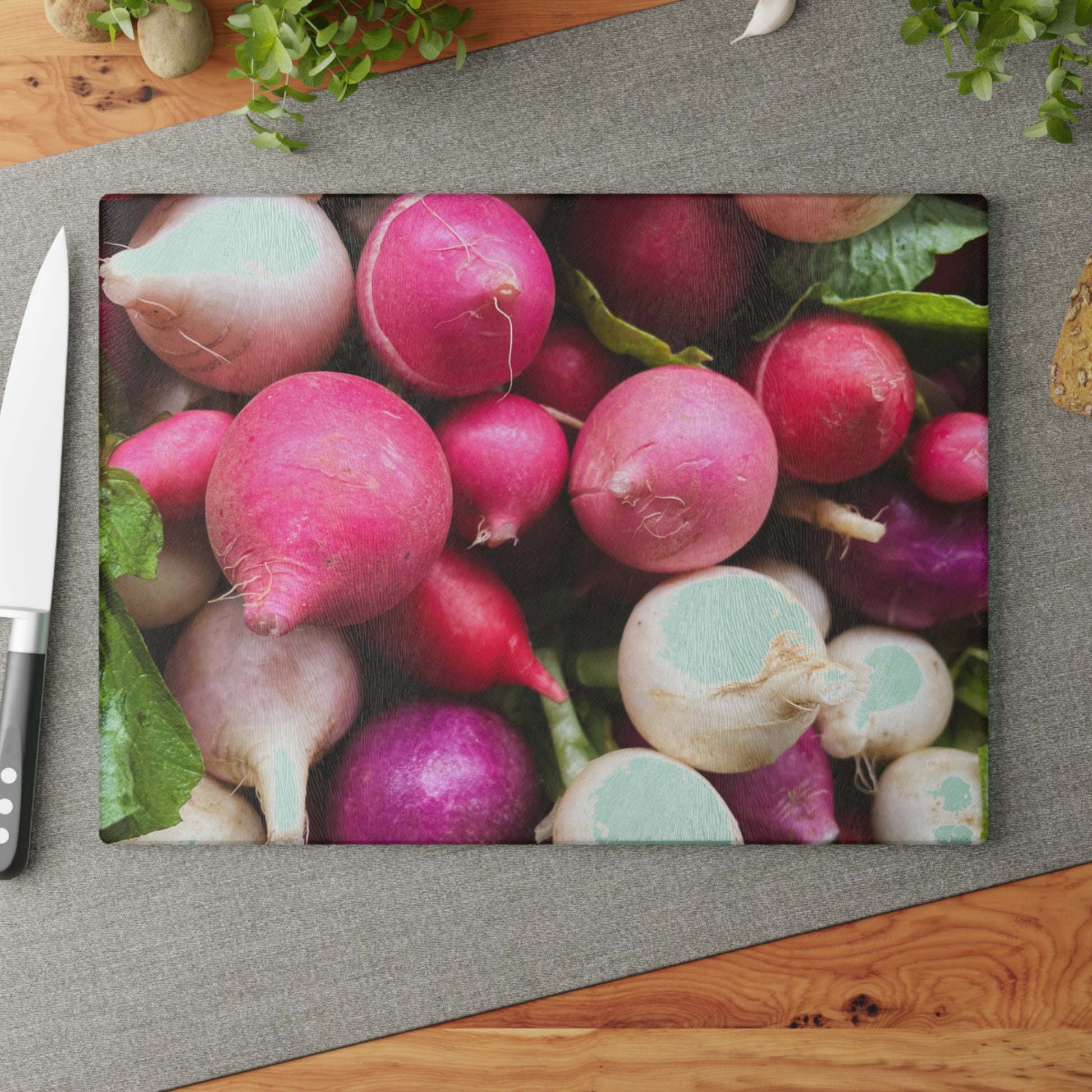 Colorful radishes on a cutting board with a knife