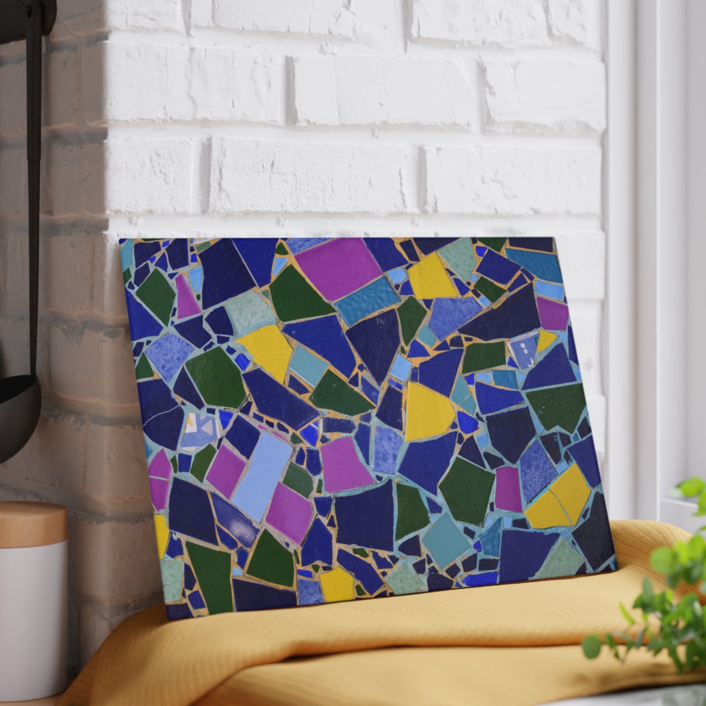 Colorful mosaic art piece on a white brick wall