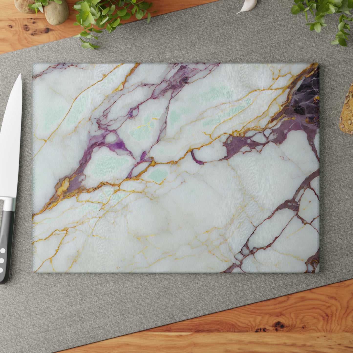 Marble-patterned cutting board on a gray surface with a knife to the left.
