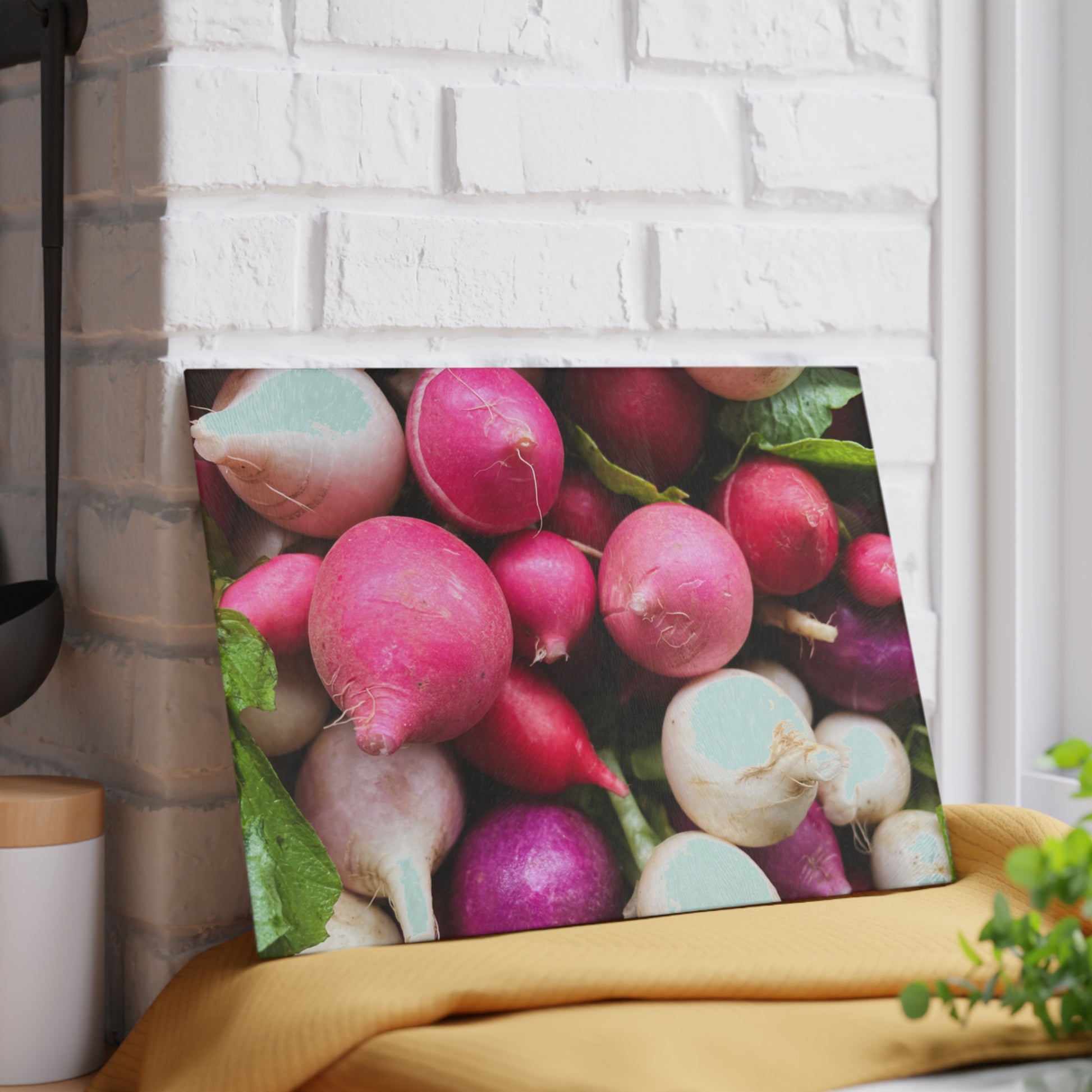 Canvas print of colorful radishes on a white brick wall.
