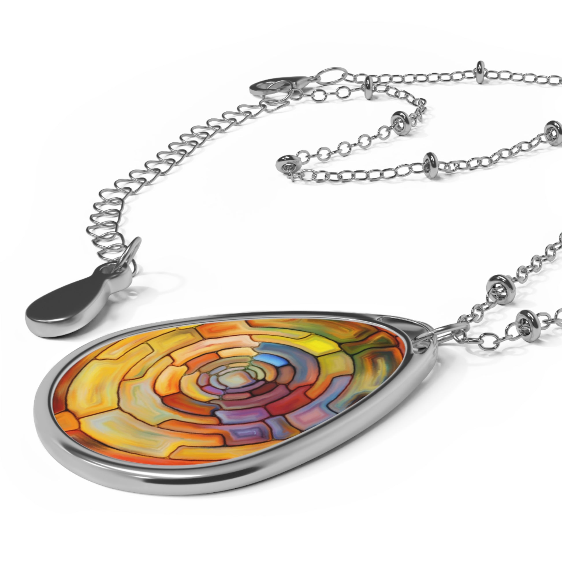 Colorful teardrop pendant on a silver chain against a white background