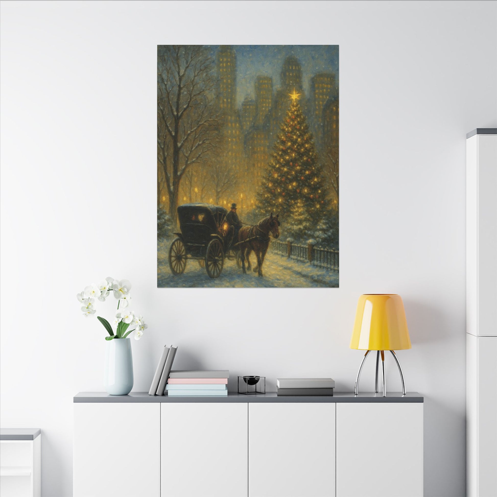 Framed artwork of a horse-drawn carriage near a Christmas tree on a wall above a white cabinet.
