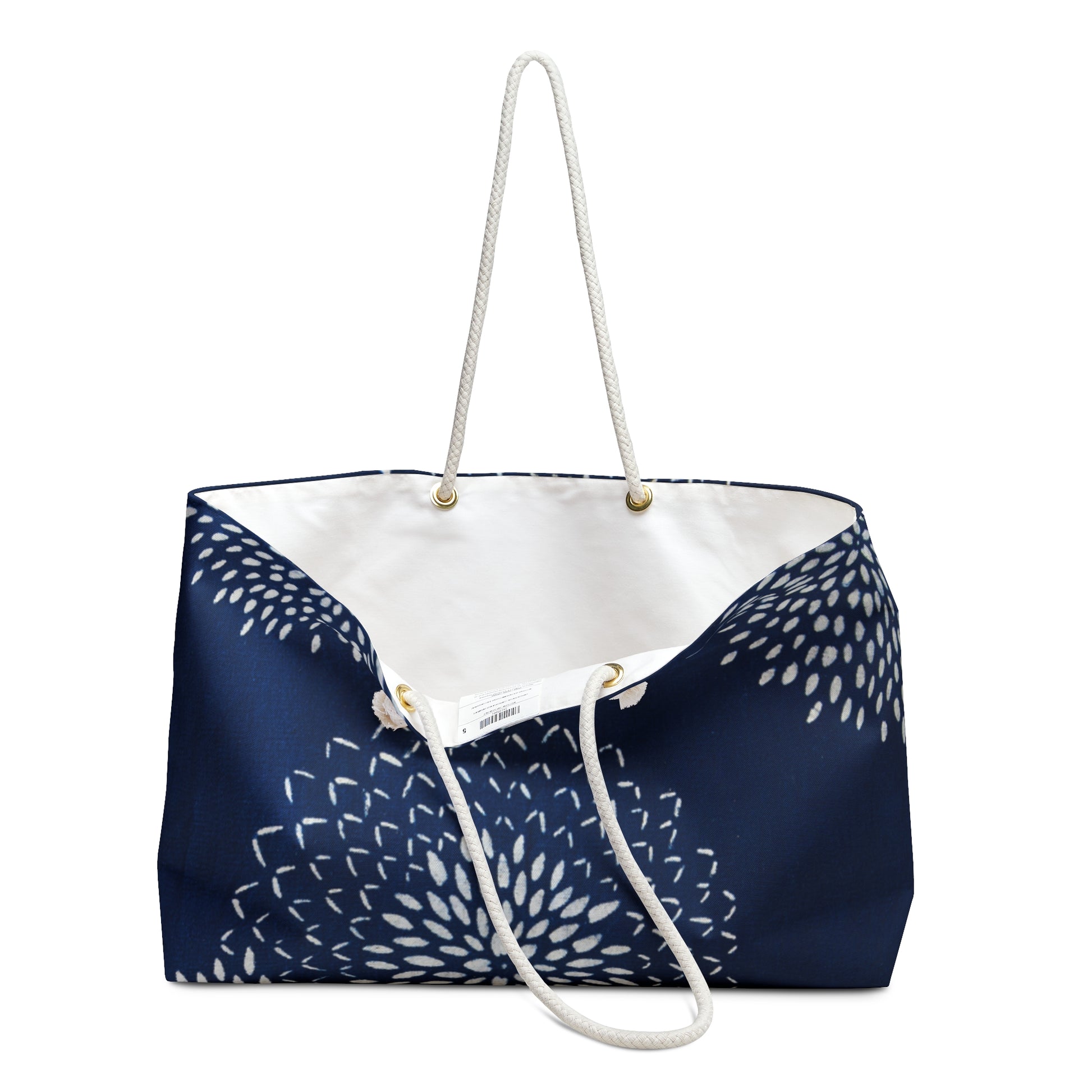 Navy blue tote bag with white floral pattern and handle on a white background