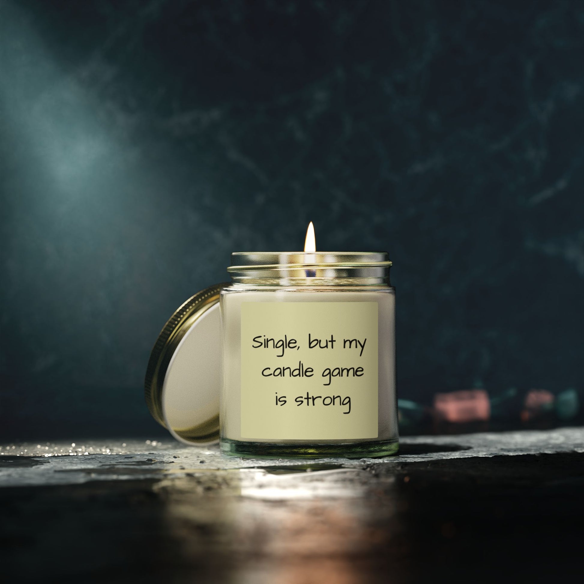 Candle in a jar with a humorous label on a dark background
