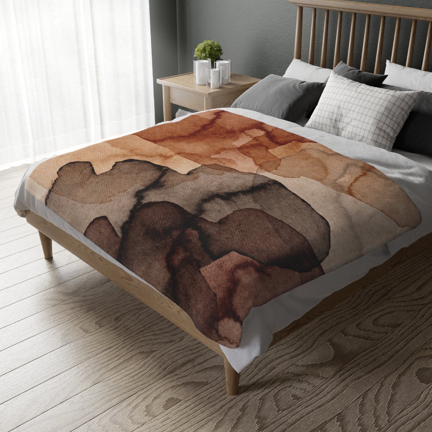 Bed with a brown abstract patterned blanket in a bedroom setting.