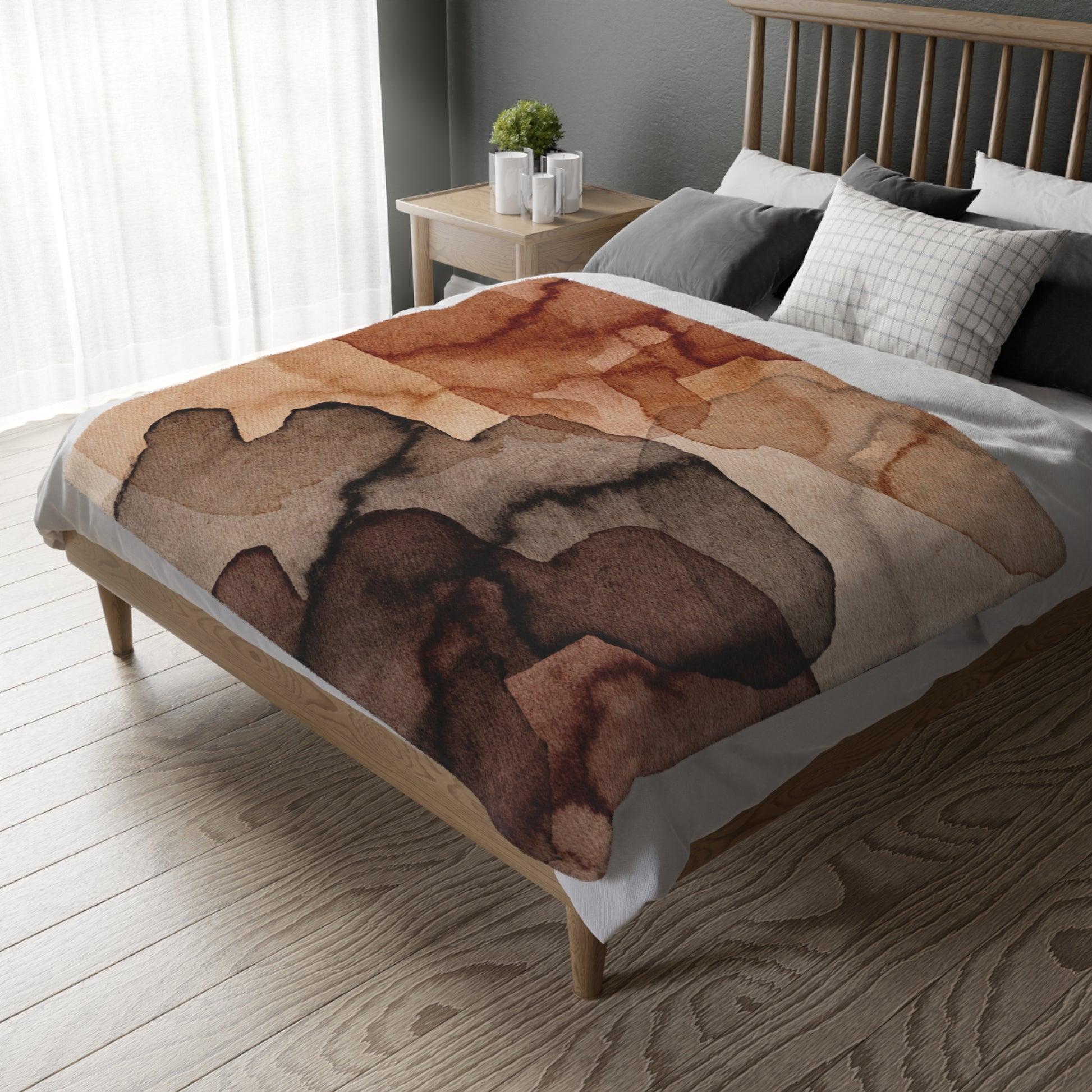 Bed with a brown abstract patterned blanket in a bedroom setting.