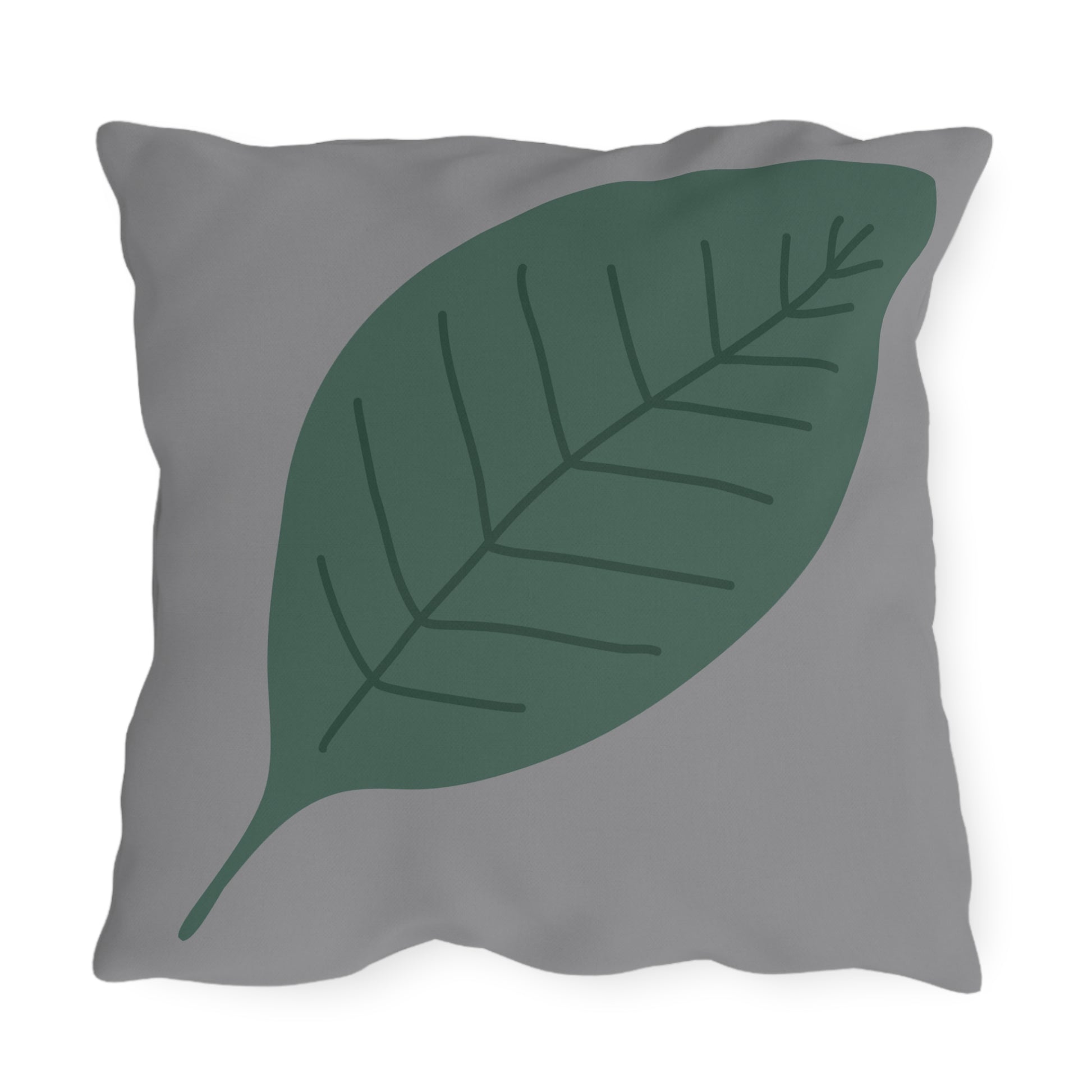 Gray pillow with a green leaf design on a white background