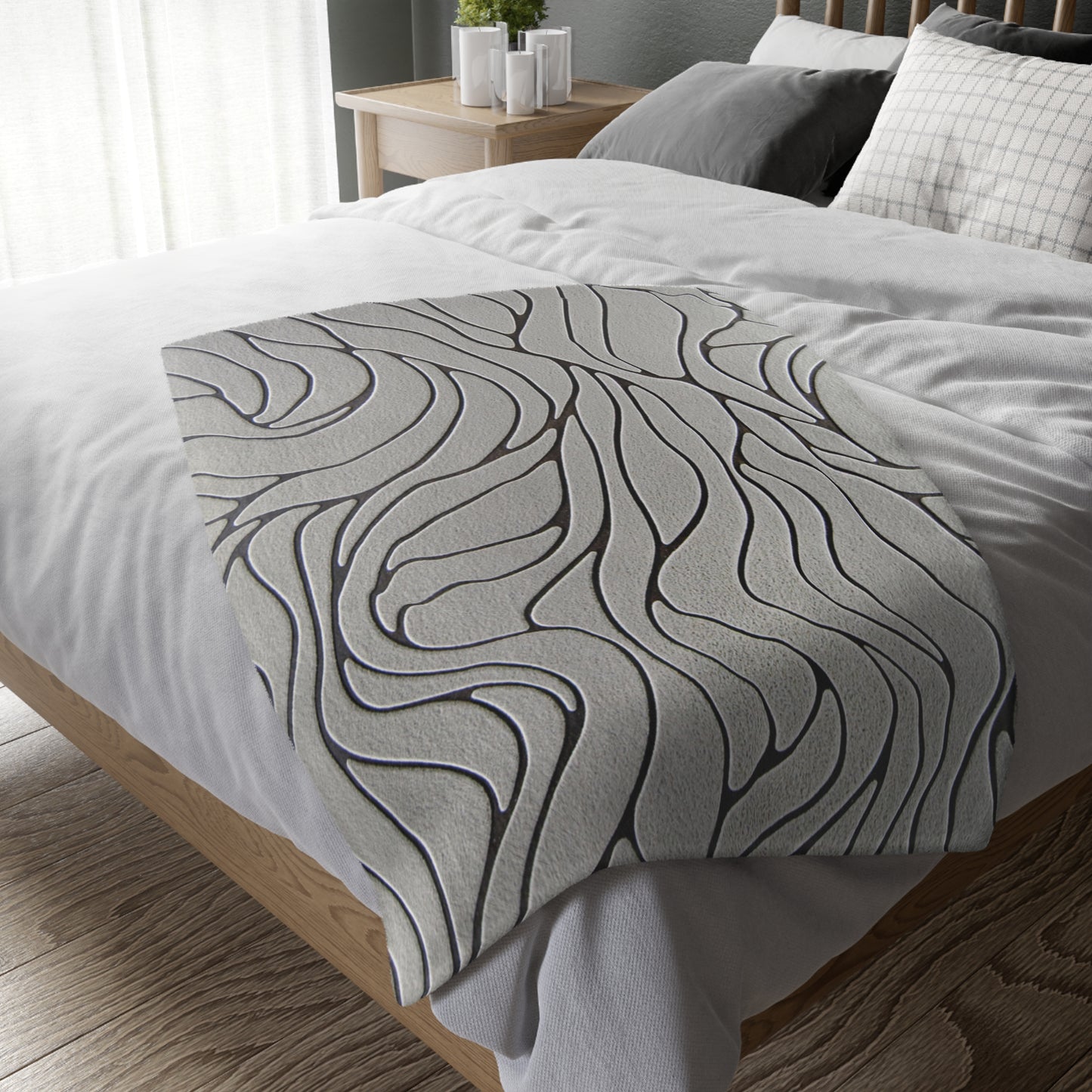 Gray textured comforter on a bed in a bedroom setting