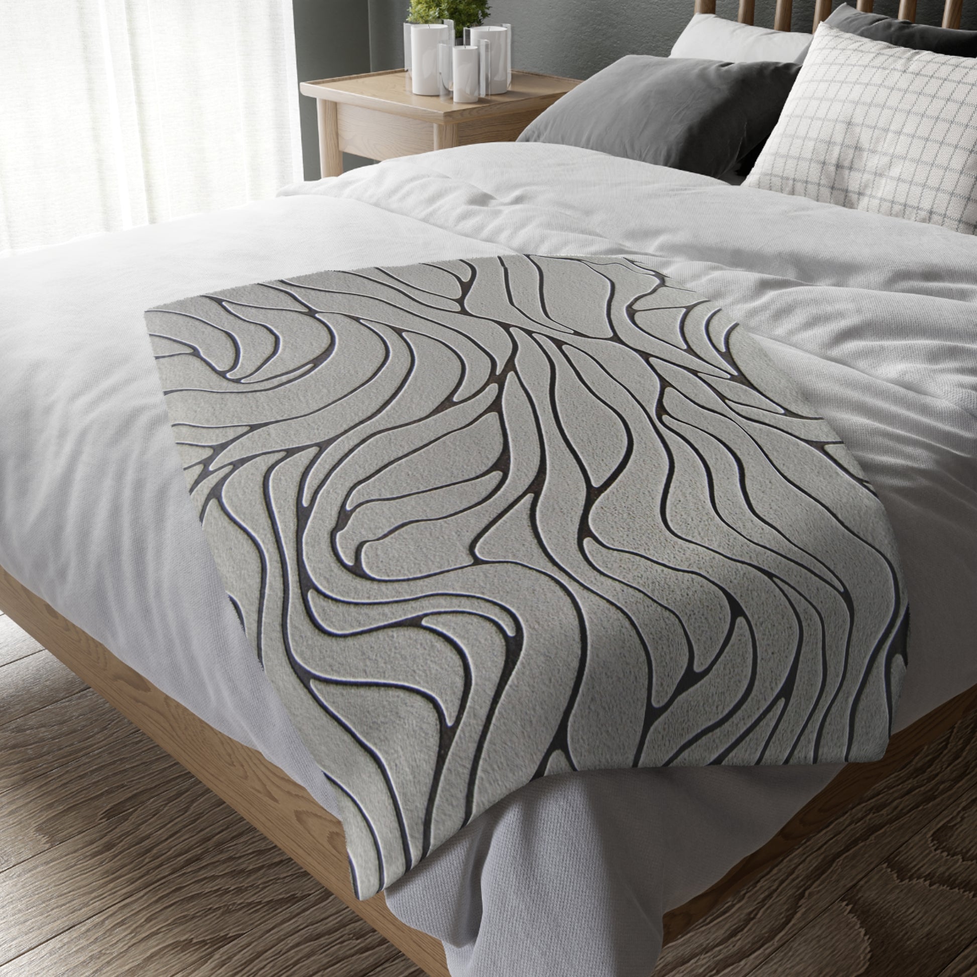 Gray textured comforter on a bed in a bedroom setting