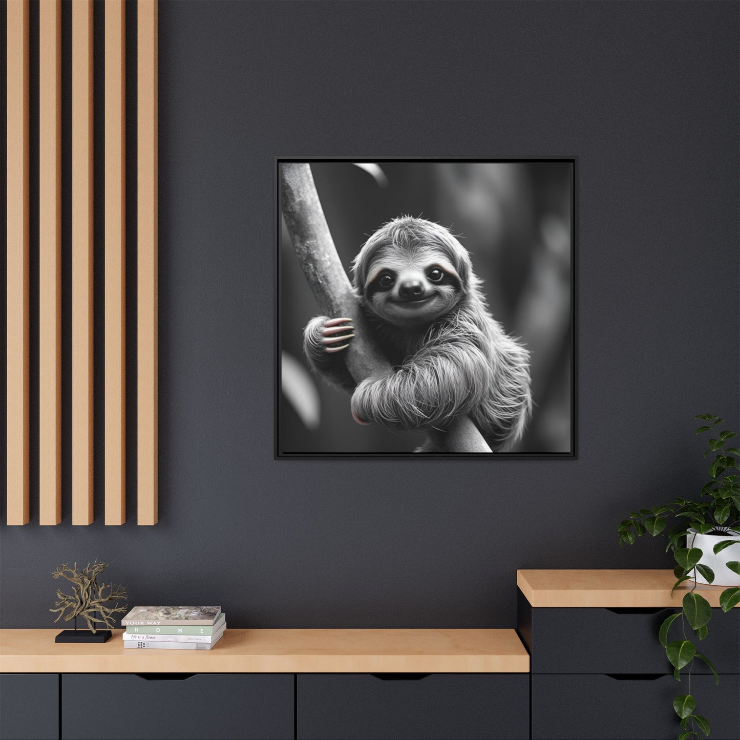 Framed black and white photo of a sloth on a dark wall with wooden shelves.